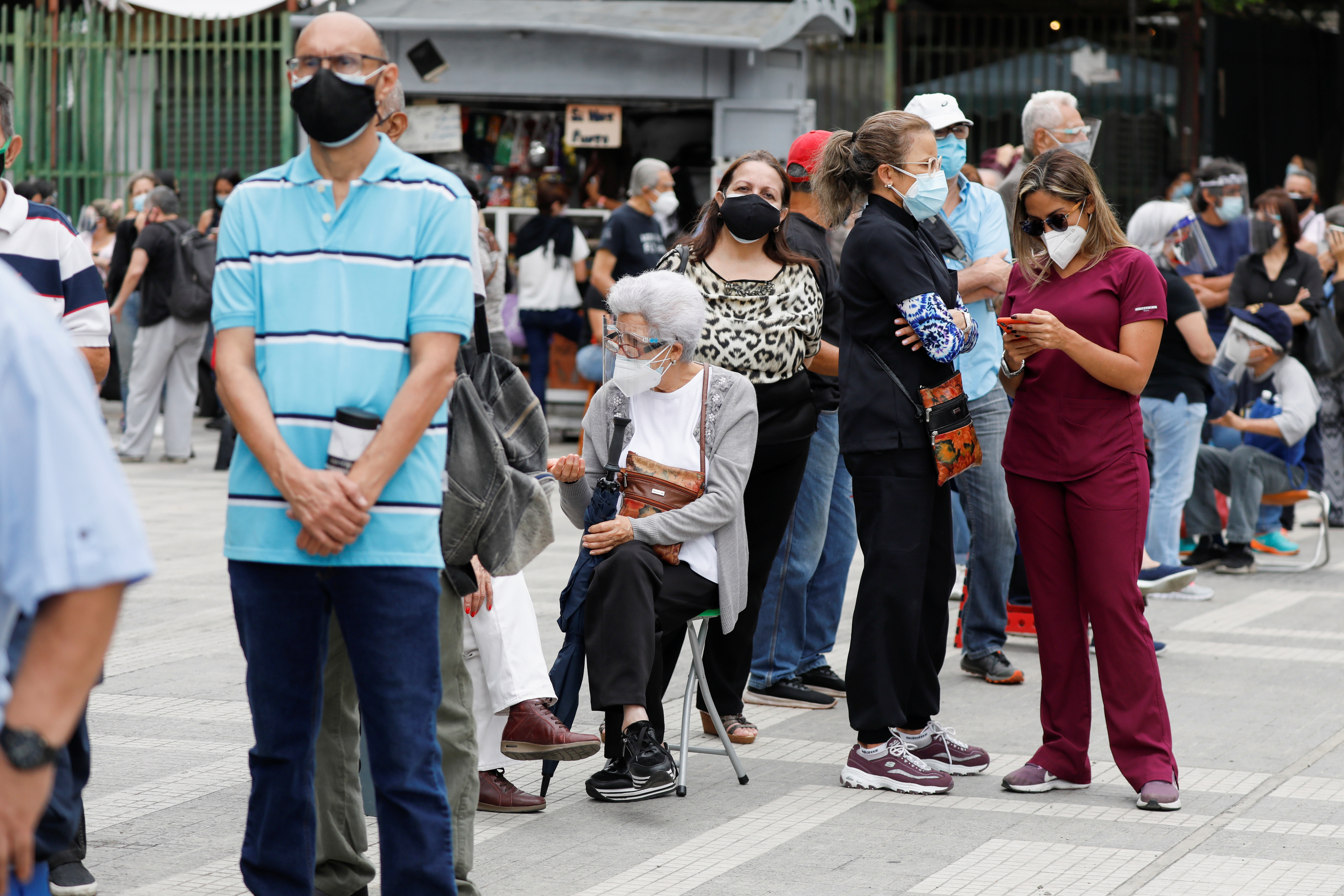 Senior citizens and health workers wait to receive their first dose of Russia's Sputnik V vaccine against the coronavirus disease (COVID-19), in Caracas