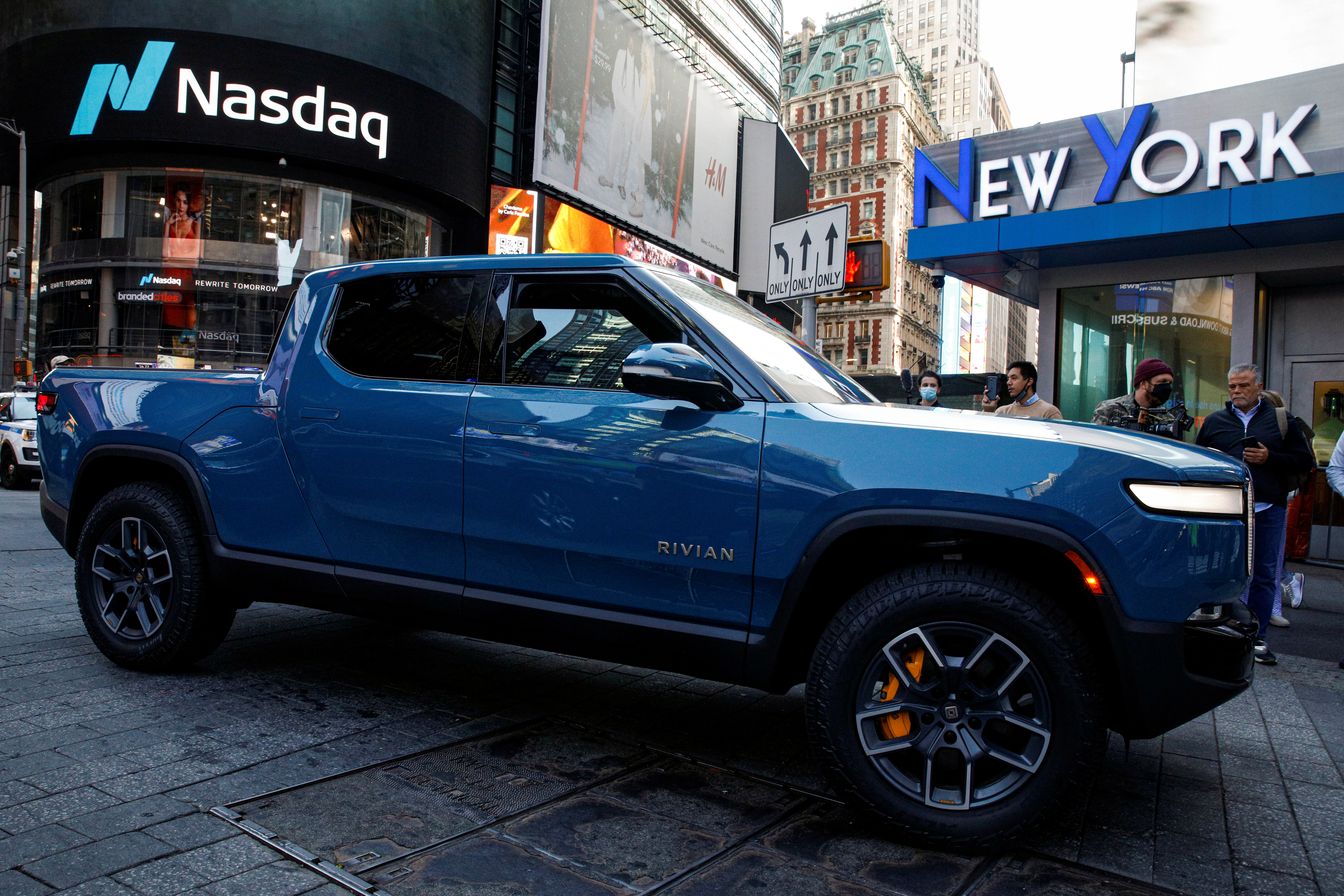 A Rivian R1T pickup, the Amazon-backed electric vehicle (EV) maker, is driven outside the Nasdaq Market site during the company’s IPO in Times Square in New York