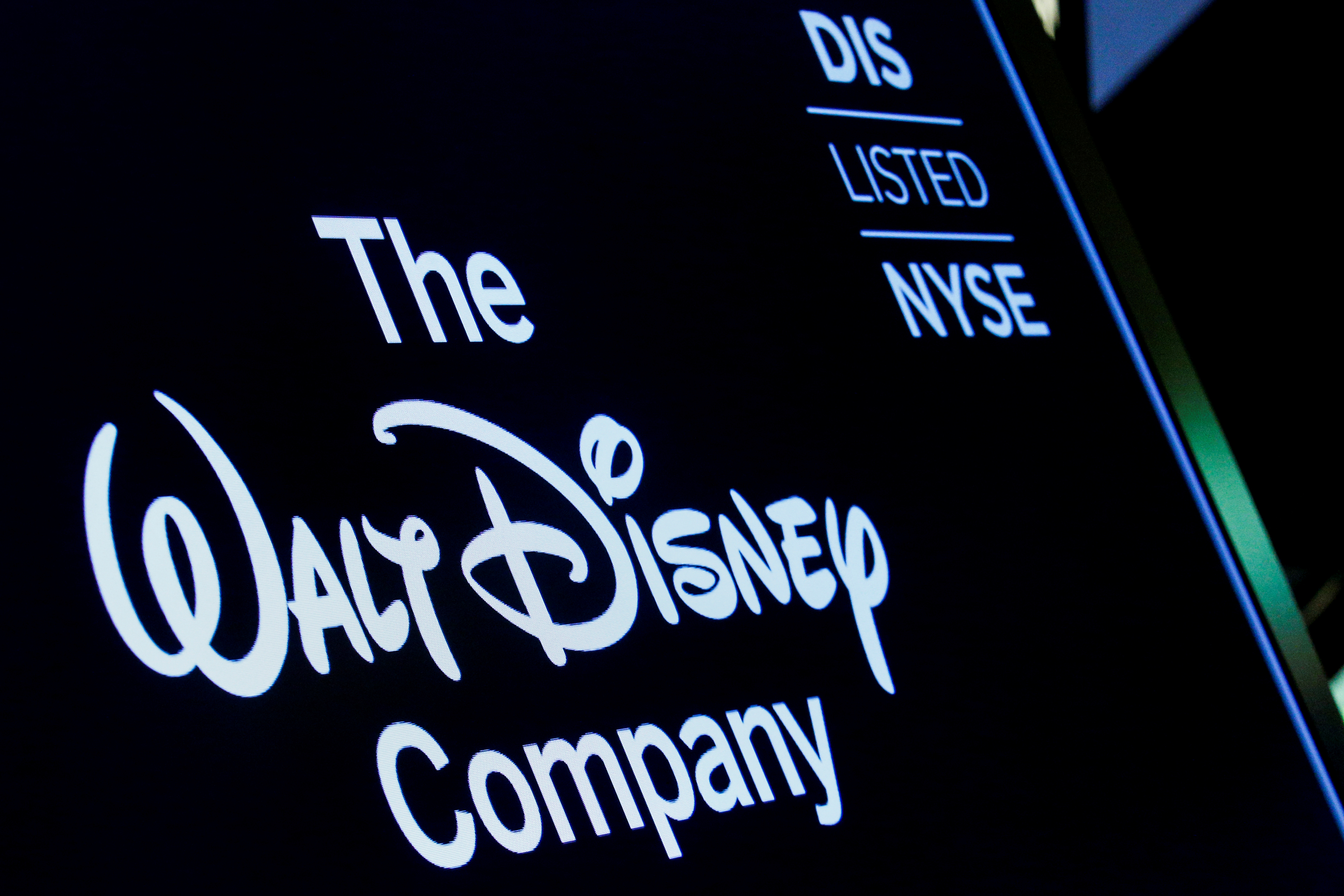 A screen shows the logo and a ticker symbol for The Walt Disney Company on the floor of the New York Stock Exchange (NYSE) in New York, U.S., December 14, 2017. REUTERS/Brendan McDermid