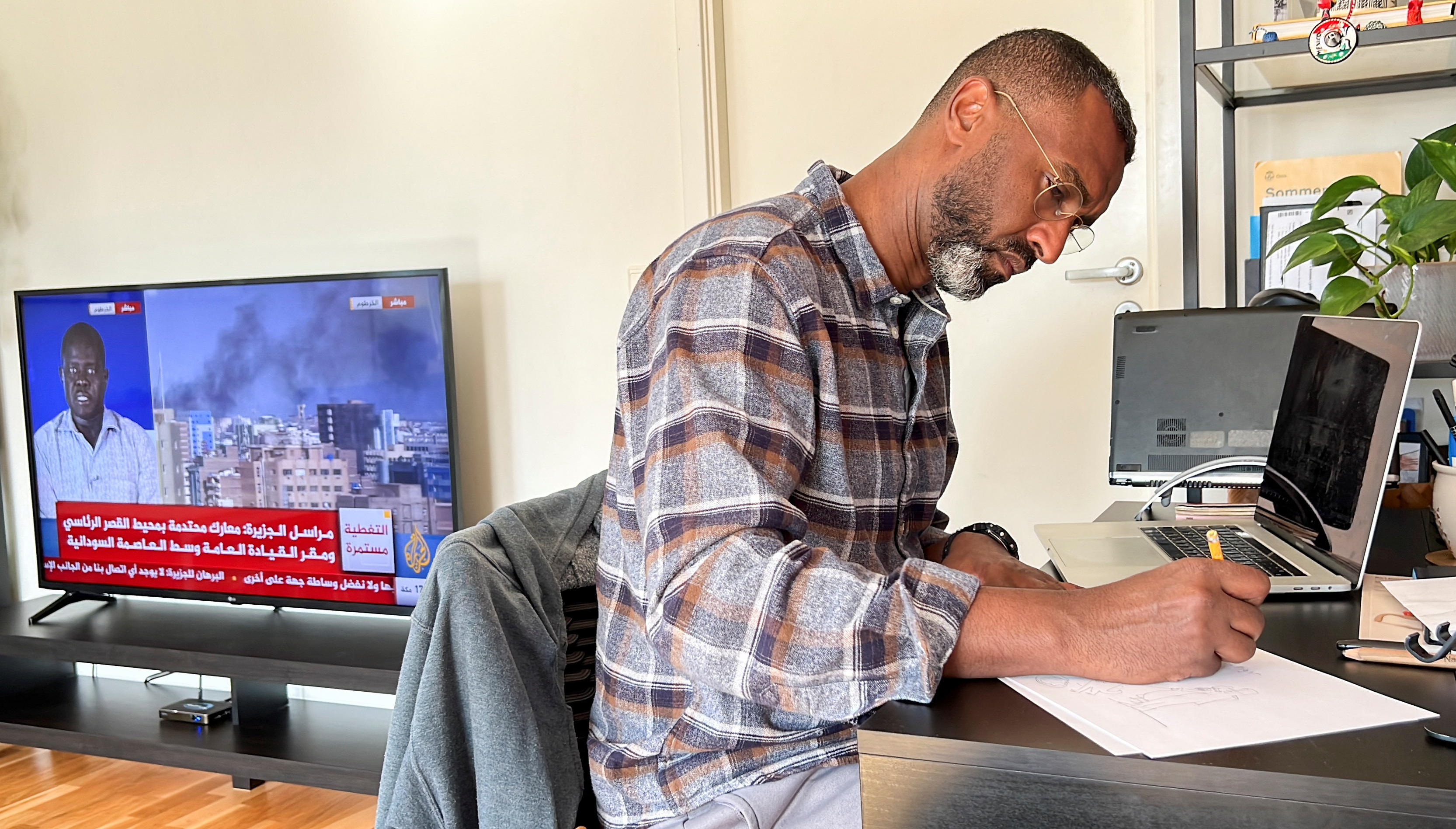 Sudanese cartoonist Khalid Albaih works at his home in Oslo