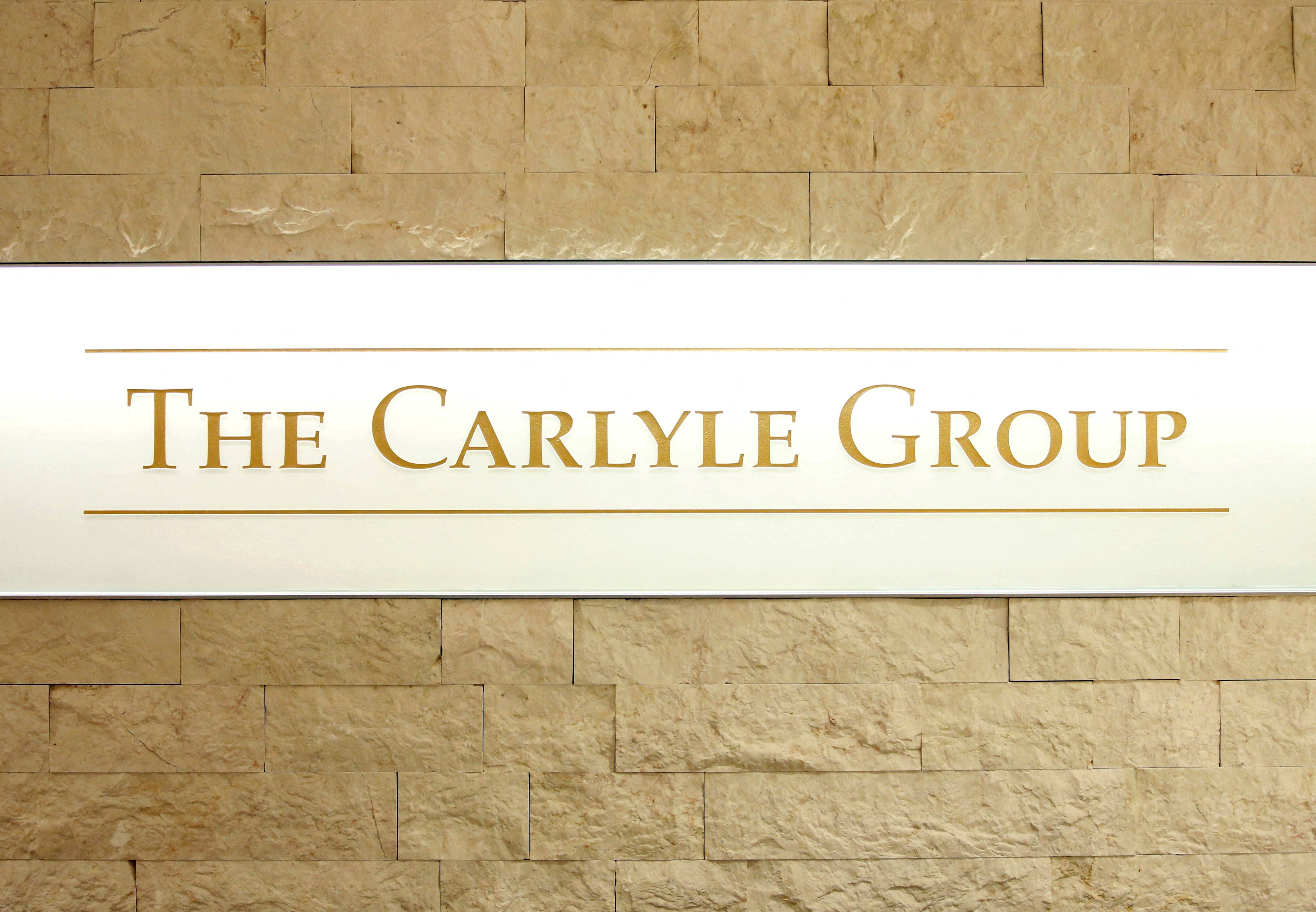 The logo of The Carlyle Group is displayed at the company's office in Tokyo