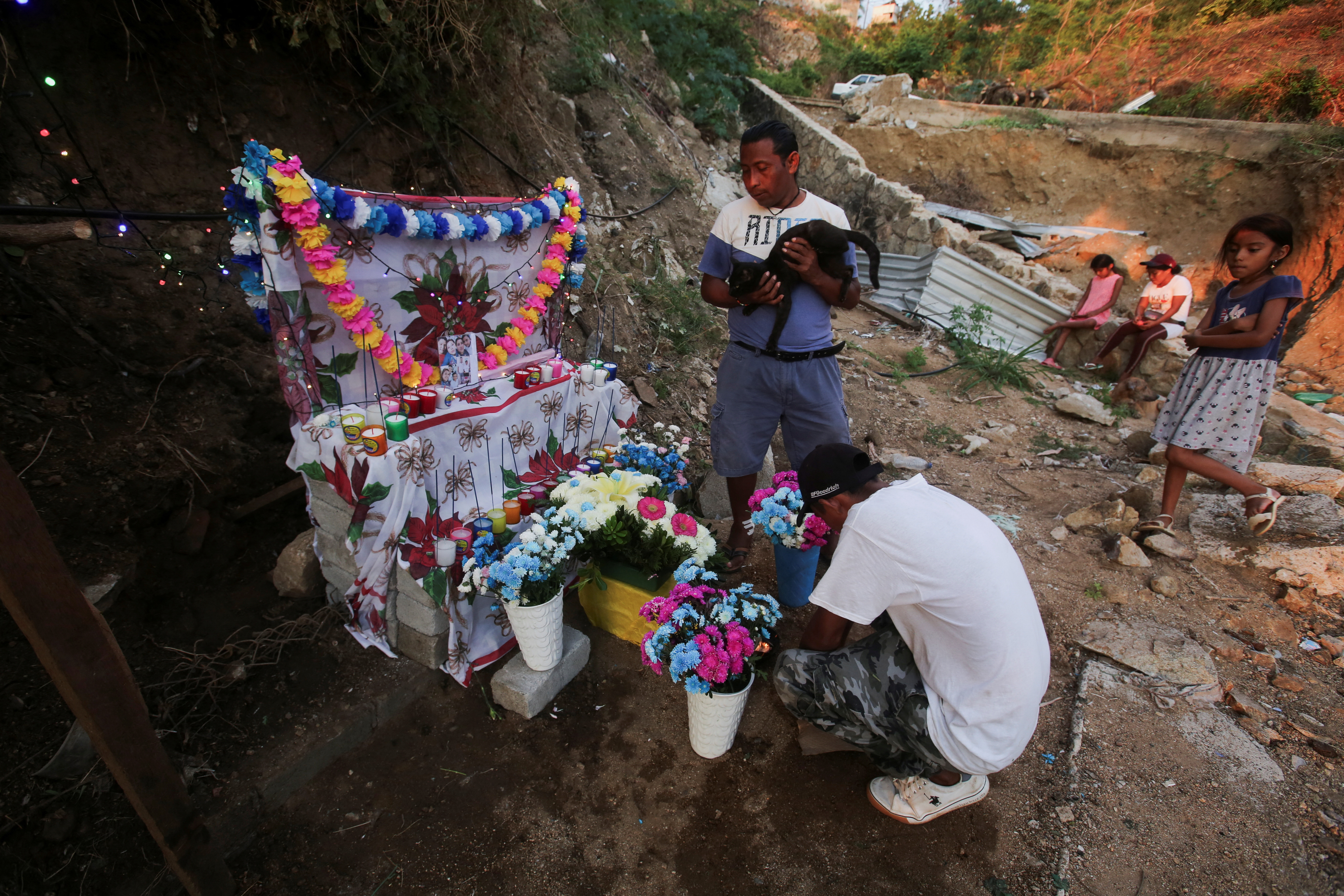 Candido Trinidad de la Cruz, who lost his family and home during Hurricane Otis, places an altar in their memory, in Acapulco