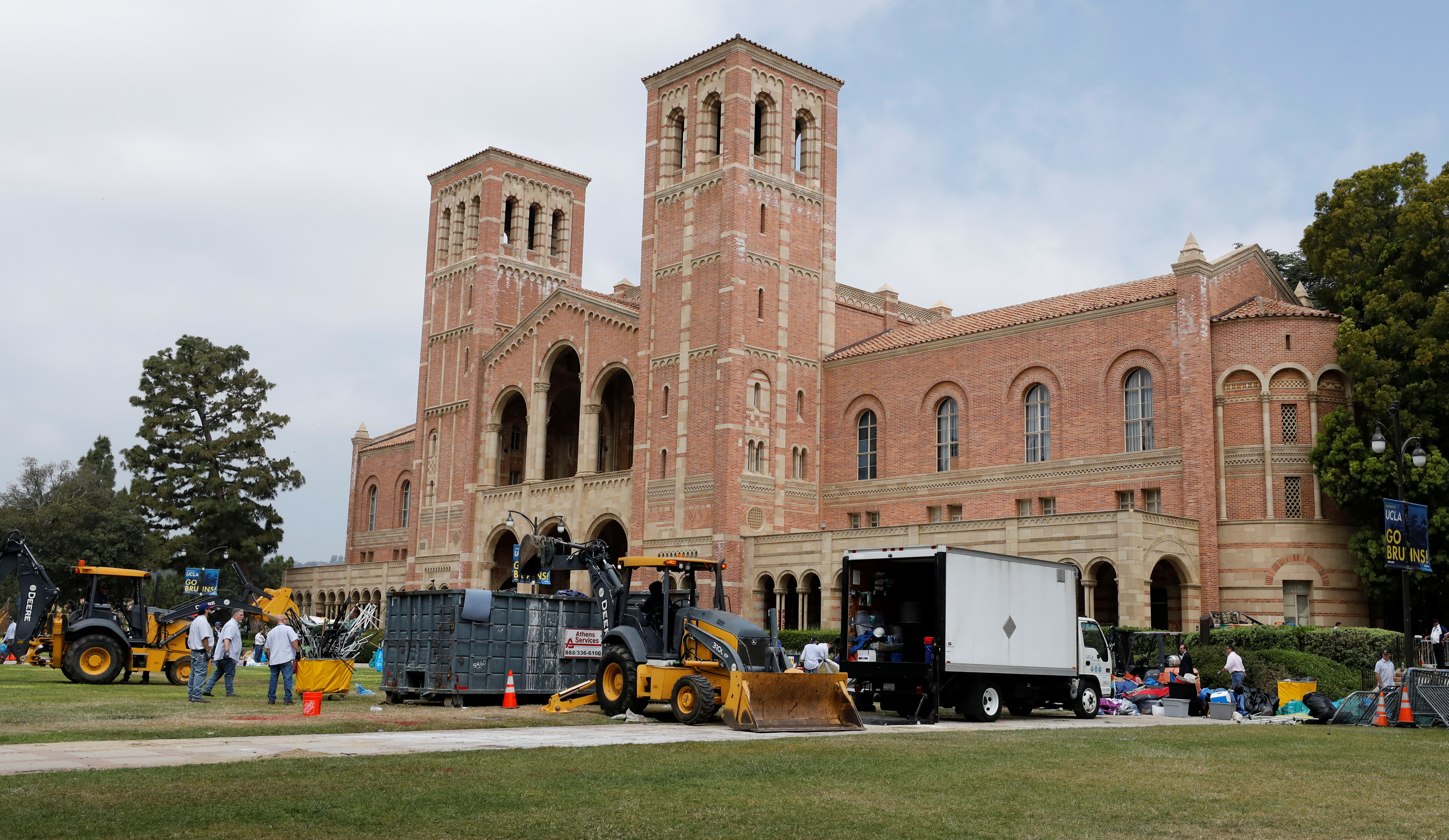 Workers remove the remnants of a protest encampment at University of California Los Angeles