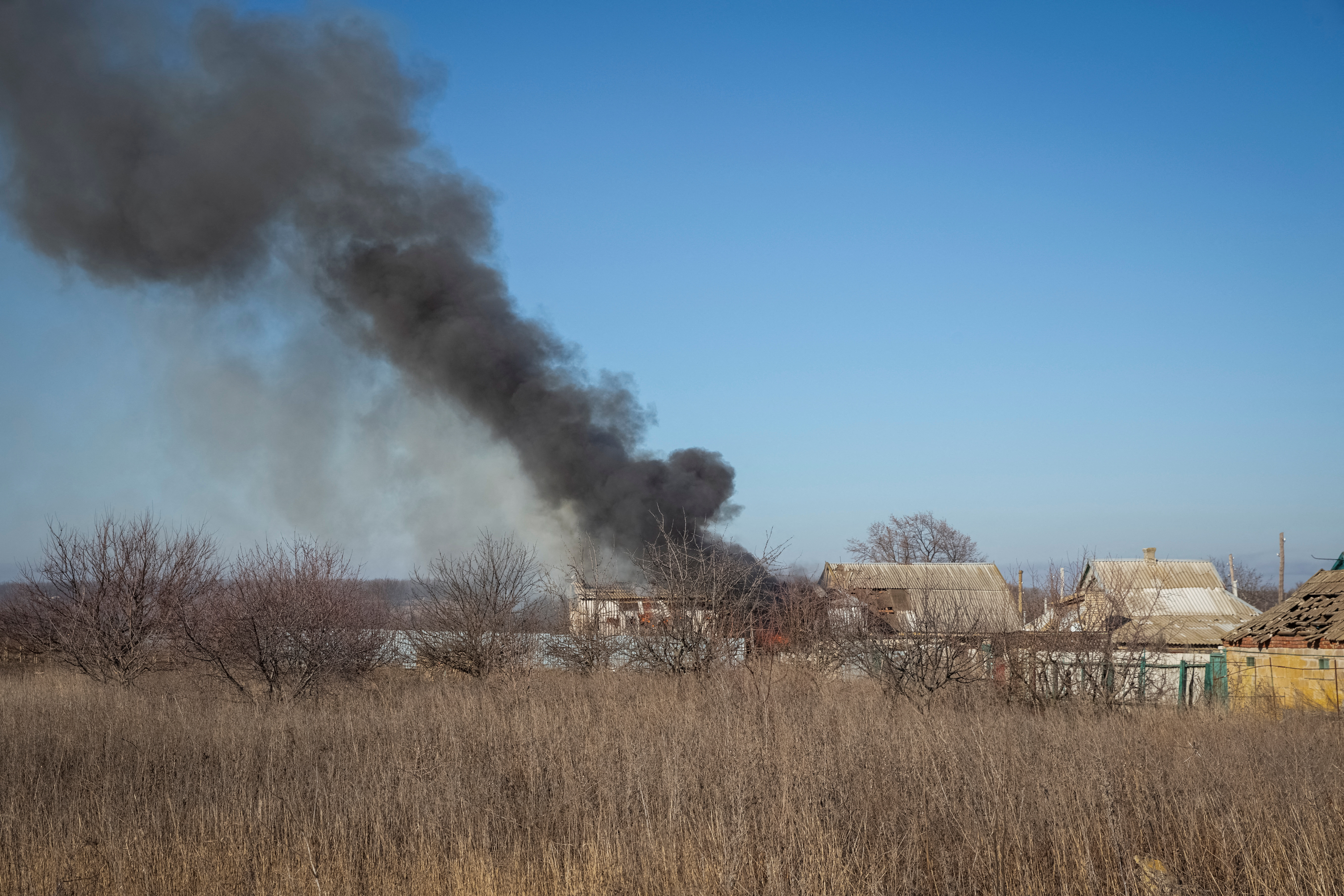 A house burns after a Russian military strike near the city of Vuhledar