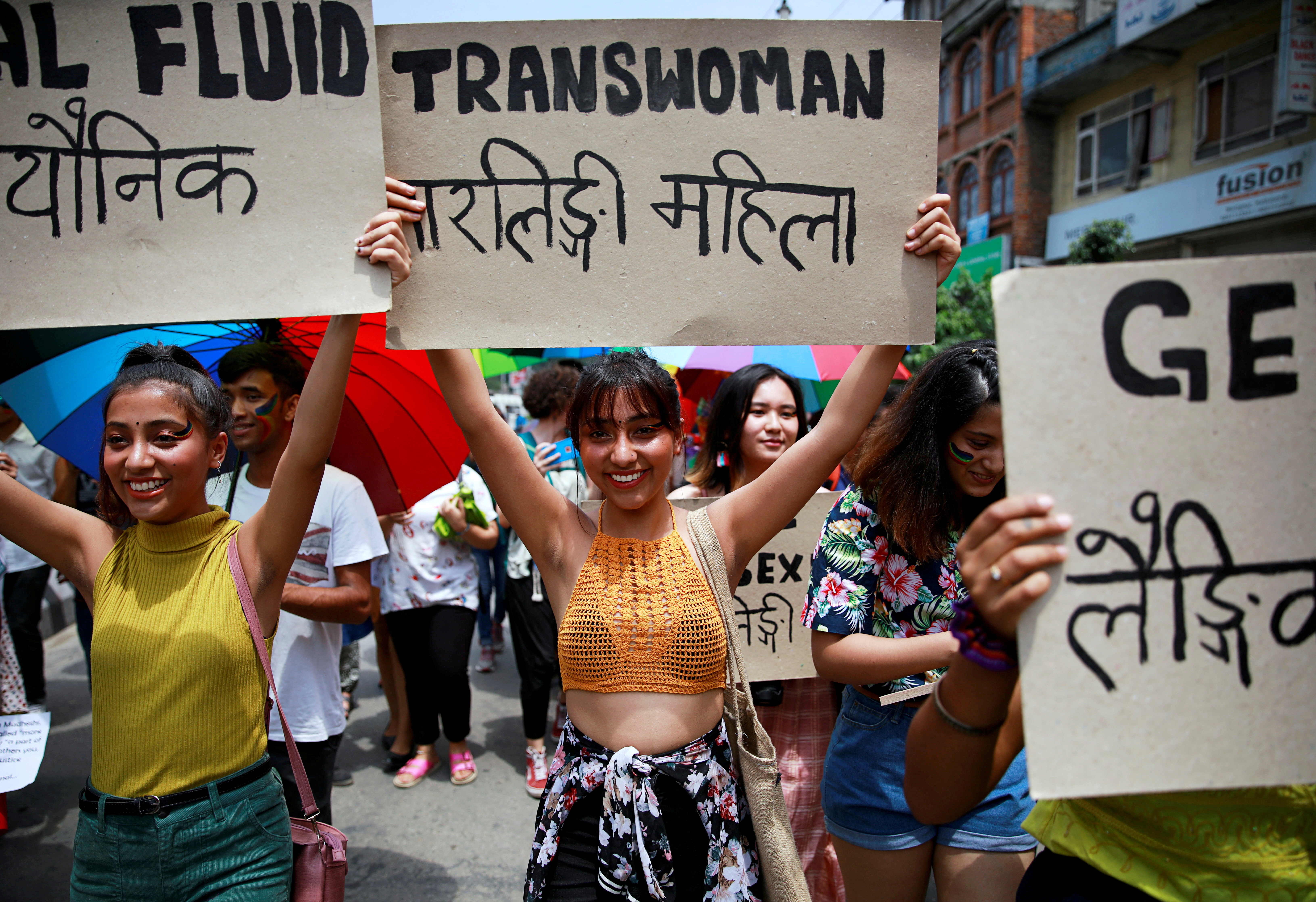 Participants hold up placards while taking part in a Gay Pride parade to mark pride month in Kathmandu