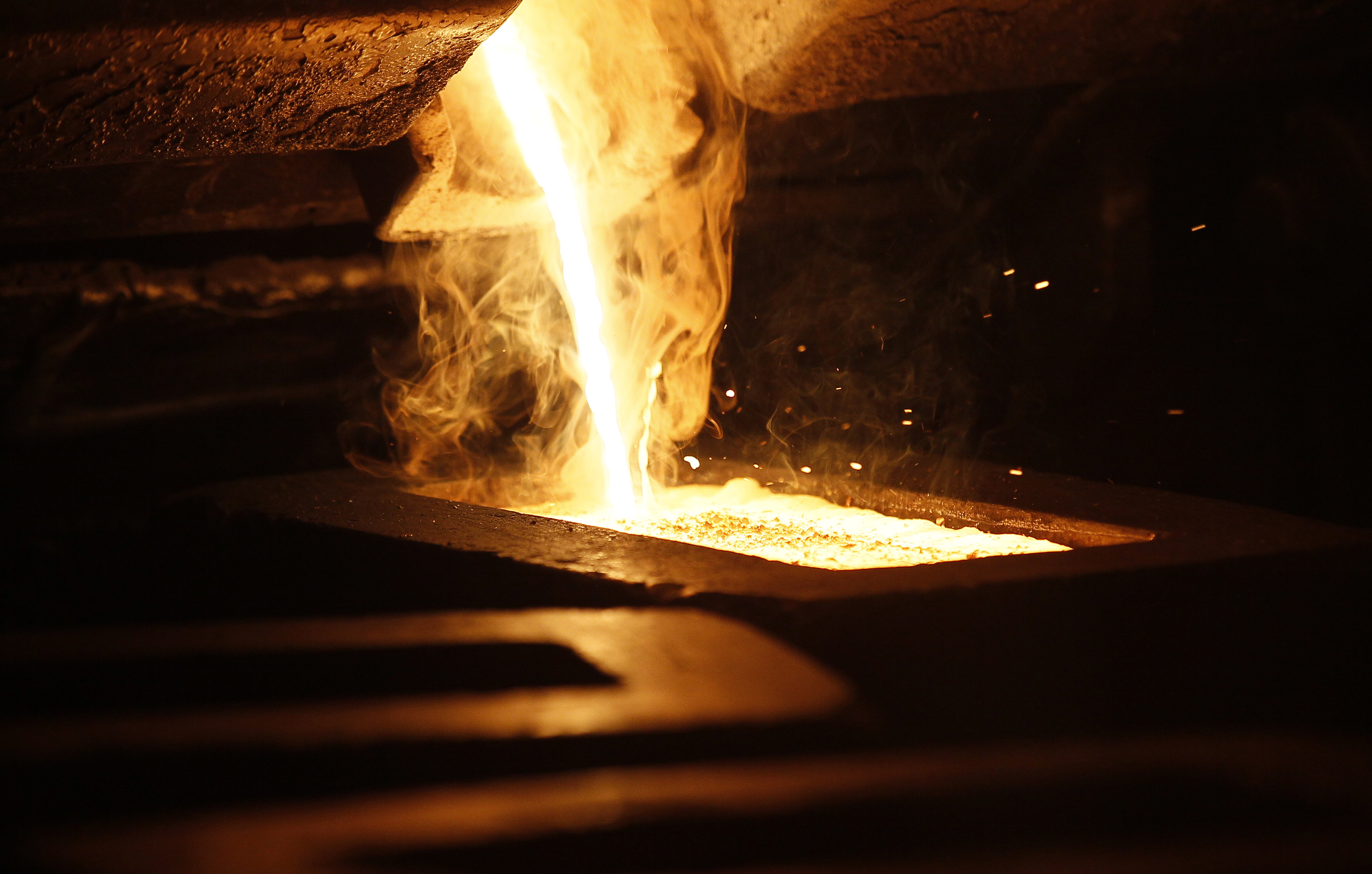 Liquid gold is poured to form gold dore bars at Newmont Mining's Carlin gold mine operation near Elko, Nevada, May 21, 2014.