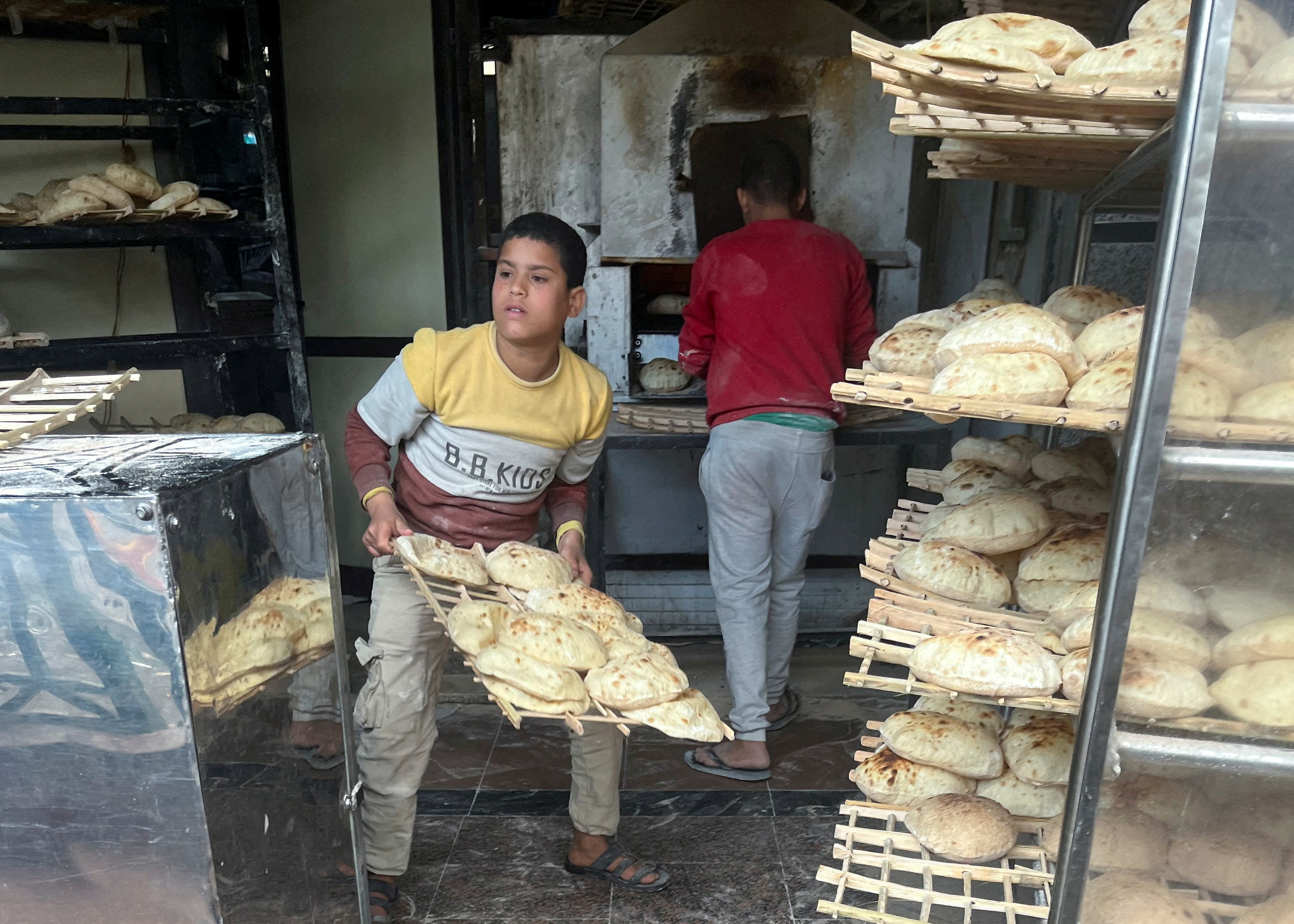 Employees arrange bread for sale at a bakery in Maadi, a suburb of Cairo