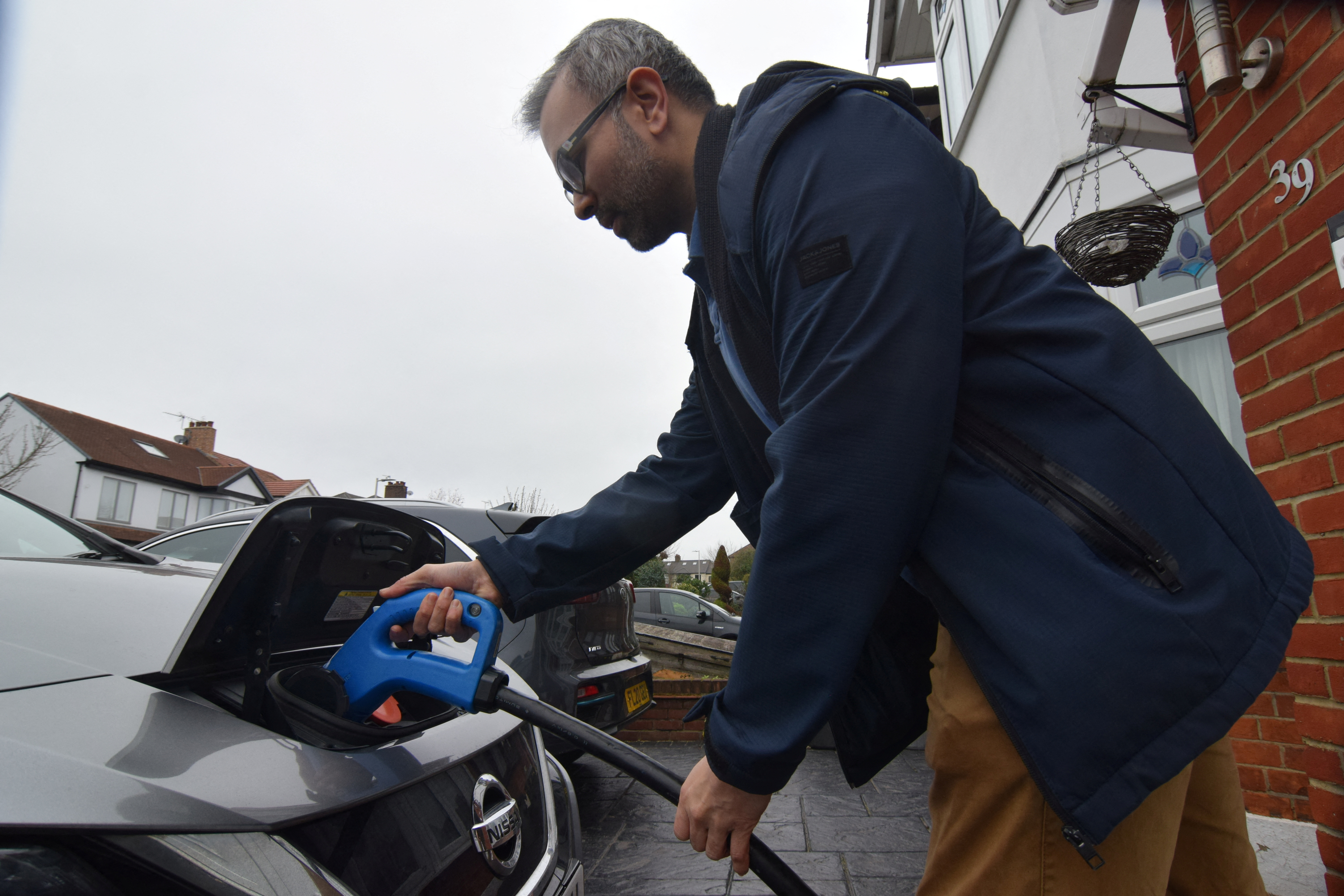 Shilpen Patel plugs in his bidirectional electric Nissan Leaf, in London