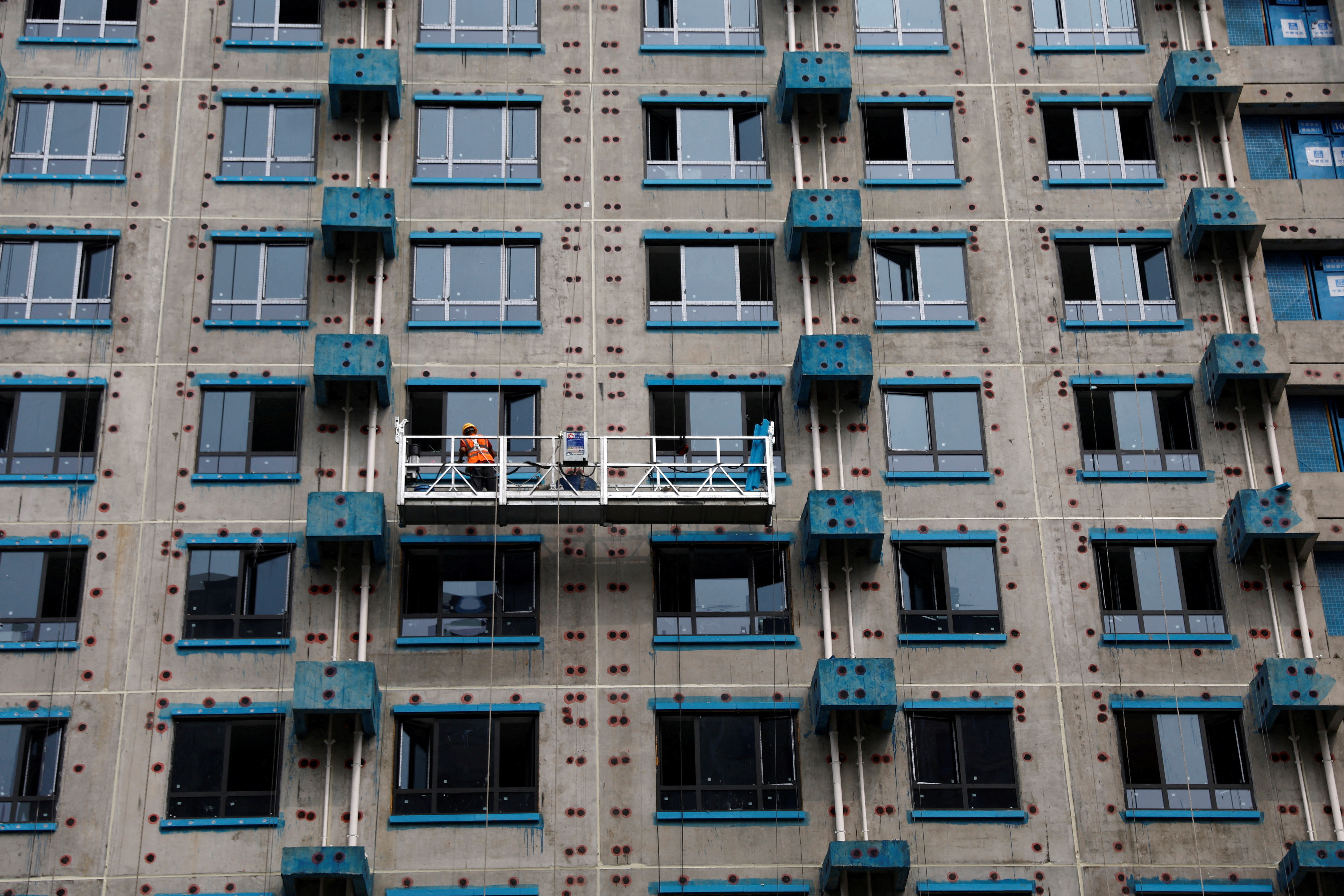 A person works at a residential building construction site in Beijing