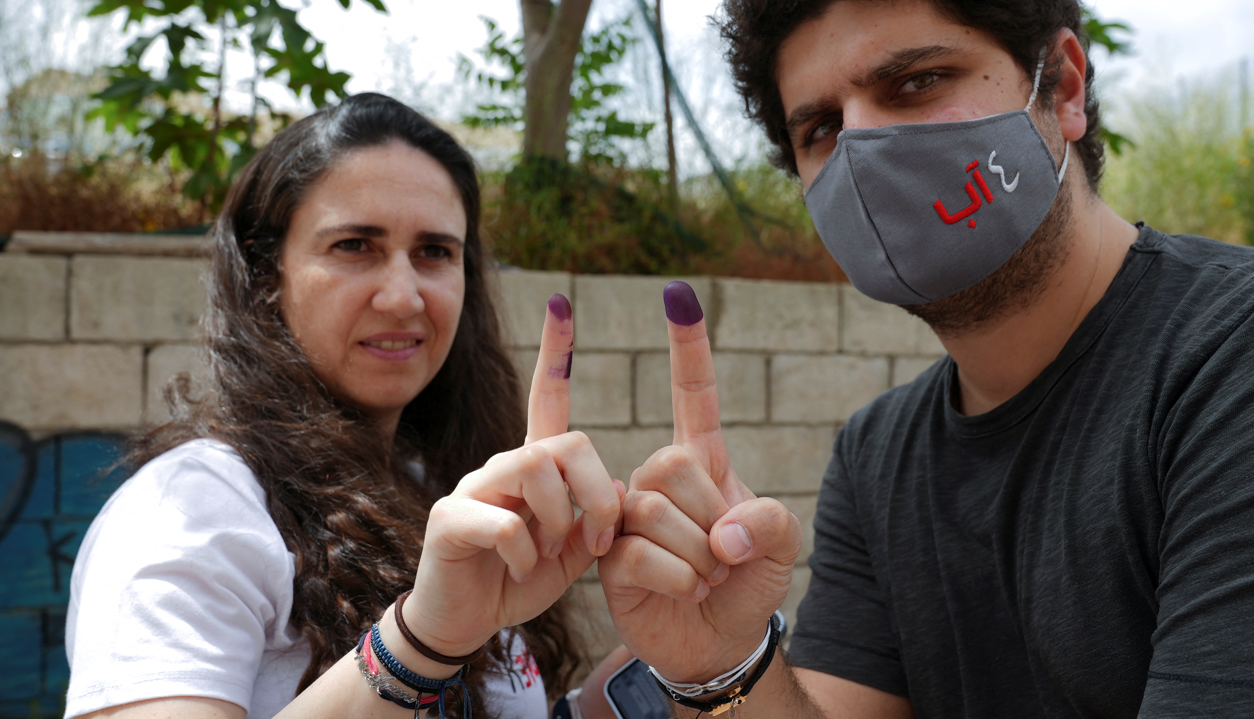 Tracy and Paul Najjar, whose daughter Alexandra was killed in the 2020 Beirut port explosion, pose as they show their ink-stained fingers after casting their votes during Lebanon's parliamentary election, in Beirut