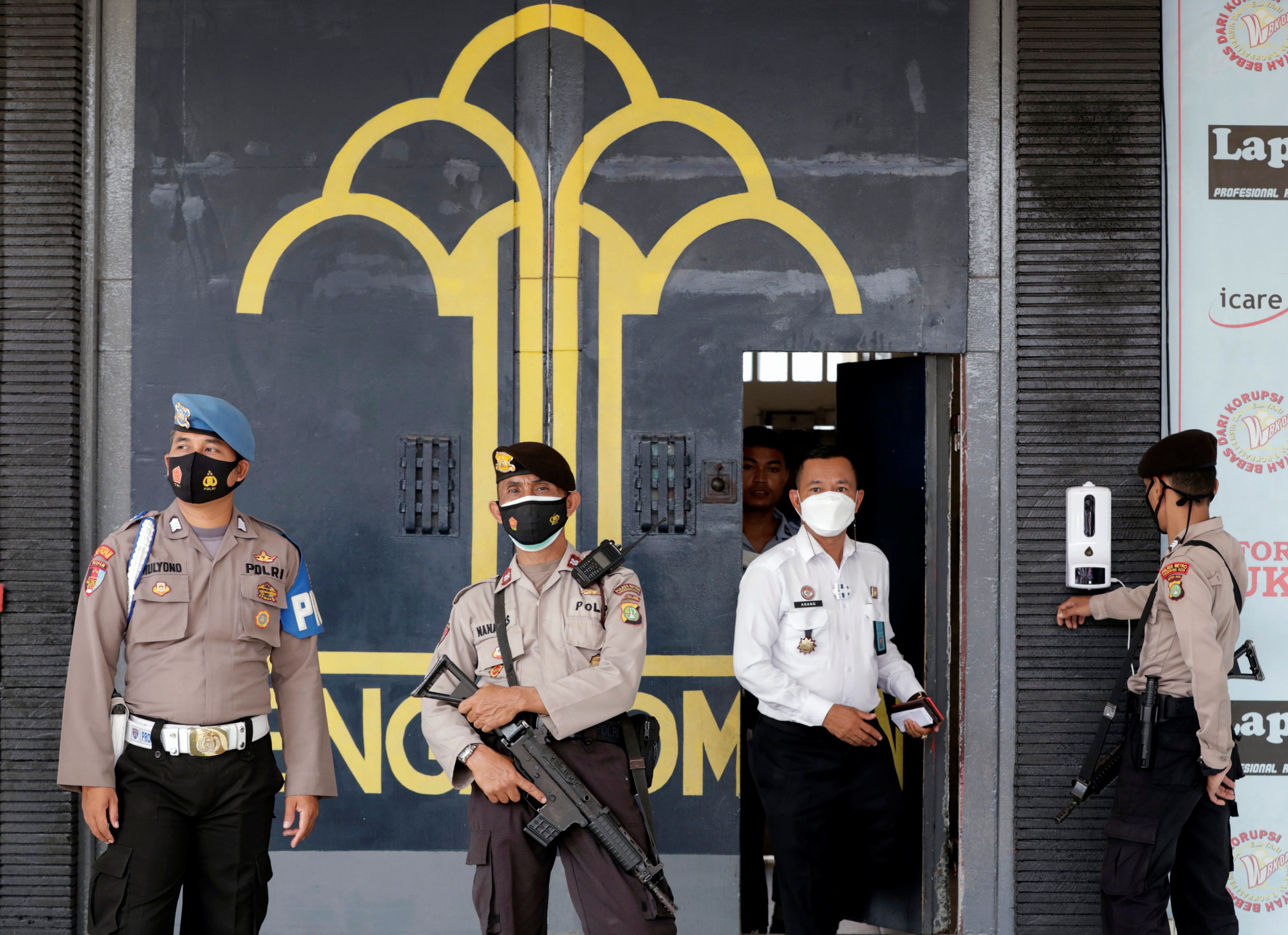 Police officer guards at the main entrance gate of Tangerang prison following a fire overnight at an overcrowded jail in Tangerang on the outskirts of Jakarta, Indonesia, September 8, 2021. REUTERS/Ajeng Dinar Ulfiana