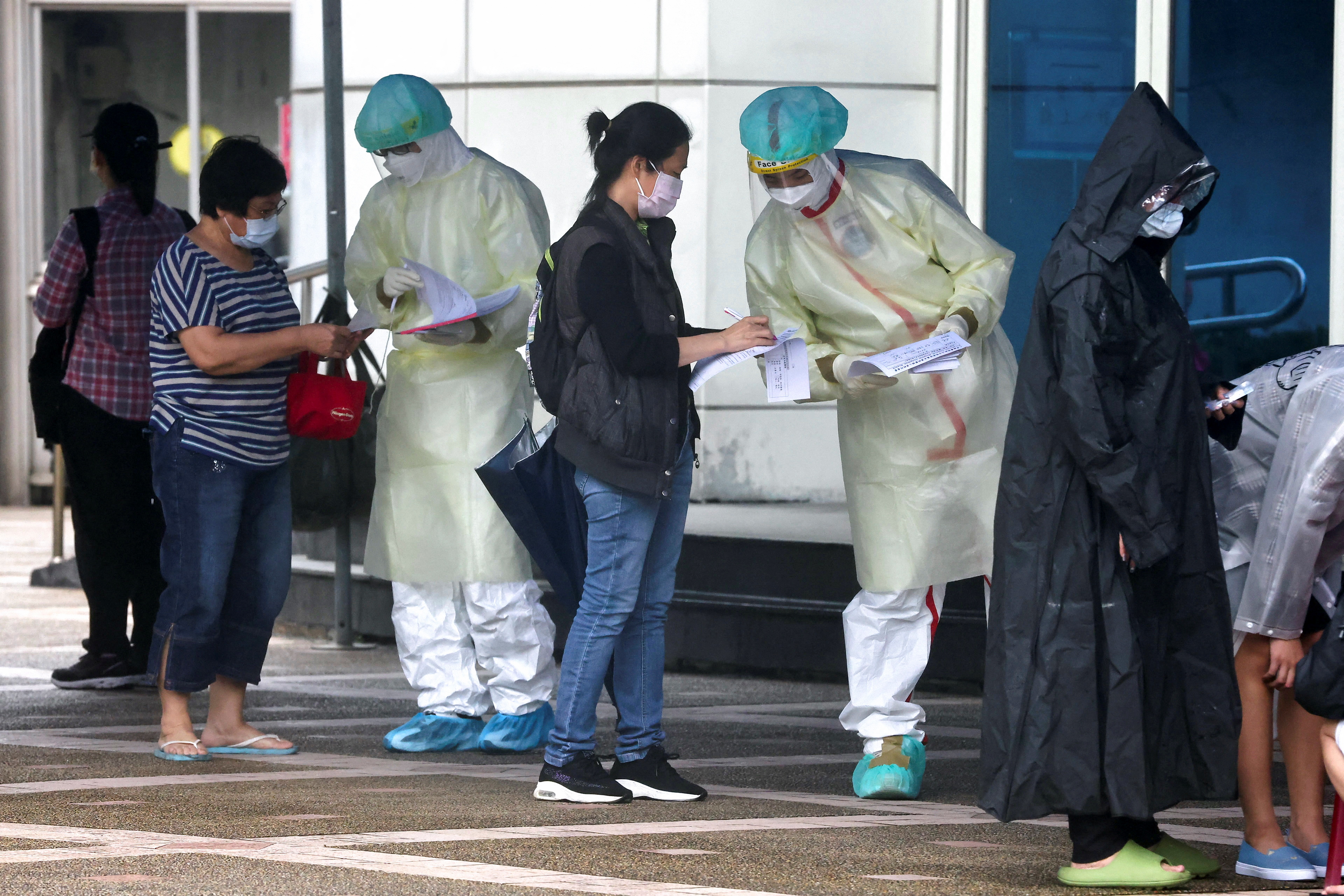 People wait to get a coronavirus disease (COVID-19) test, in Taipei