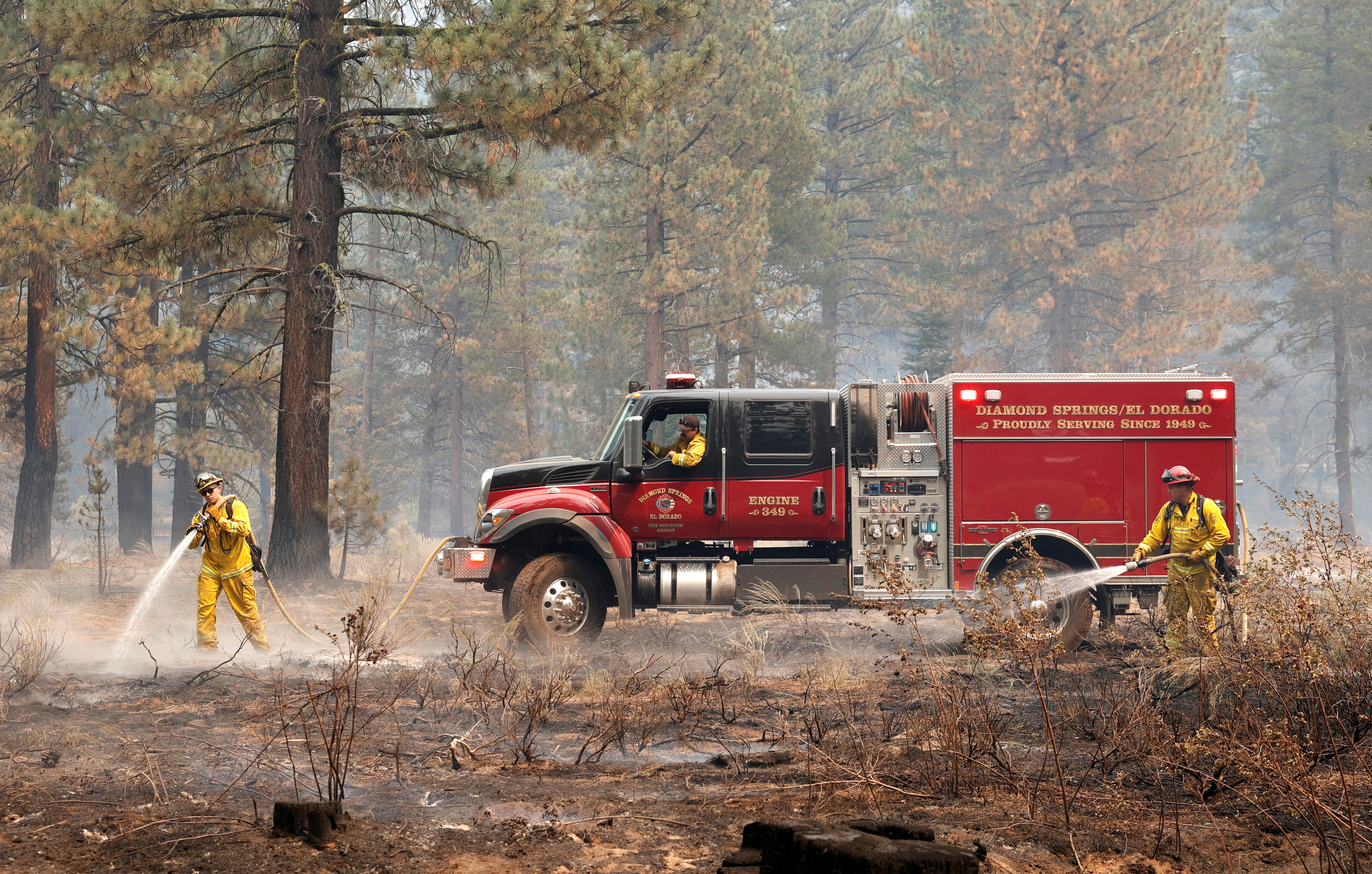 Firefighters knock down hot spots as The Caldor Fire burns near South Lake Tahoe, California, U.S., September 1, 2021. REUTERS/Fred Greaves