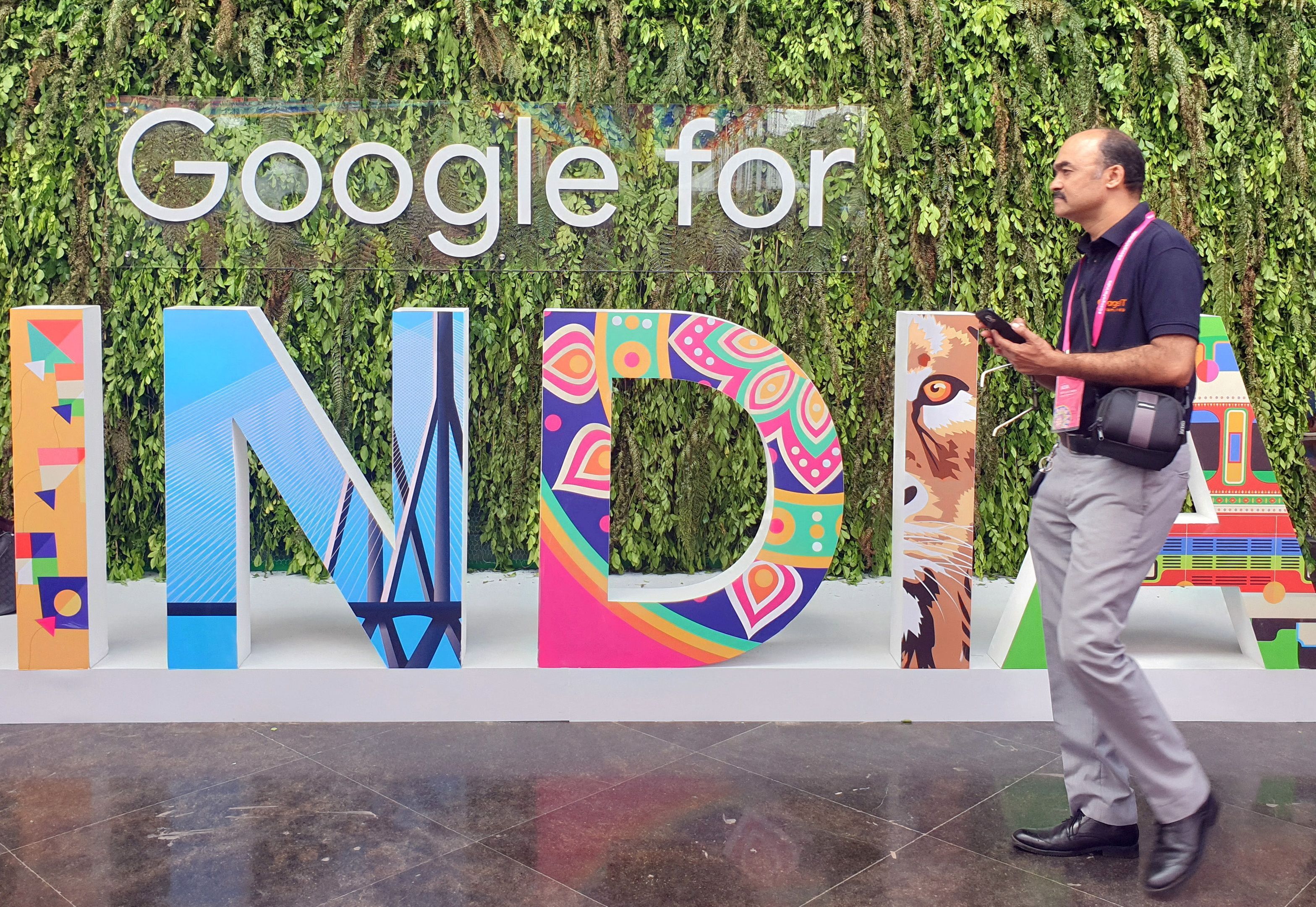 A man walks past the sign 'Google for India' at the company's annual technology event in New Delhi