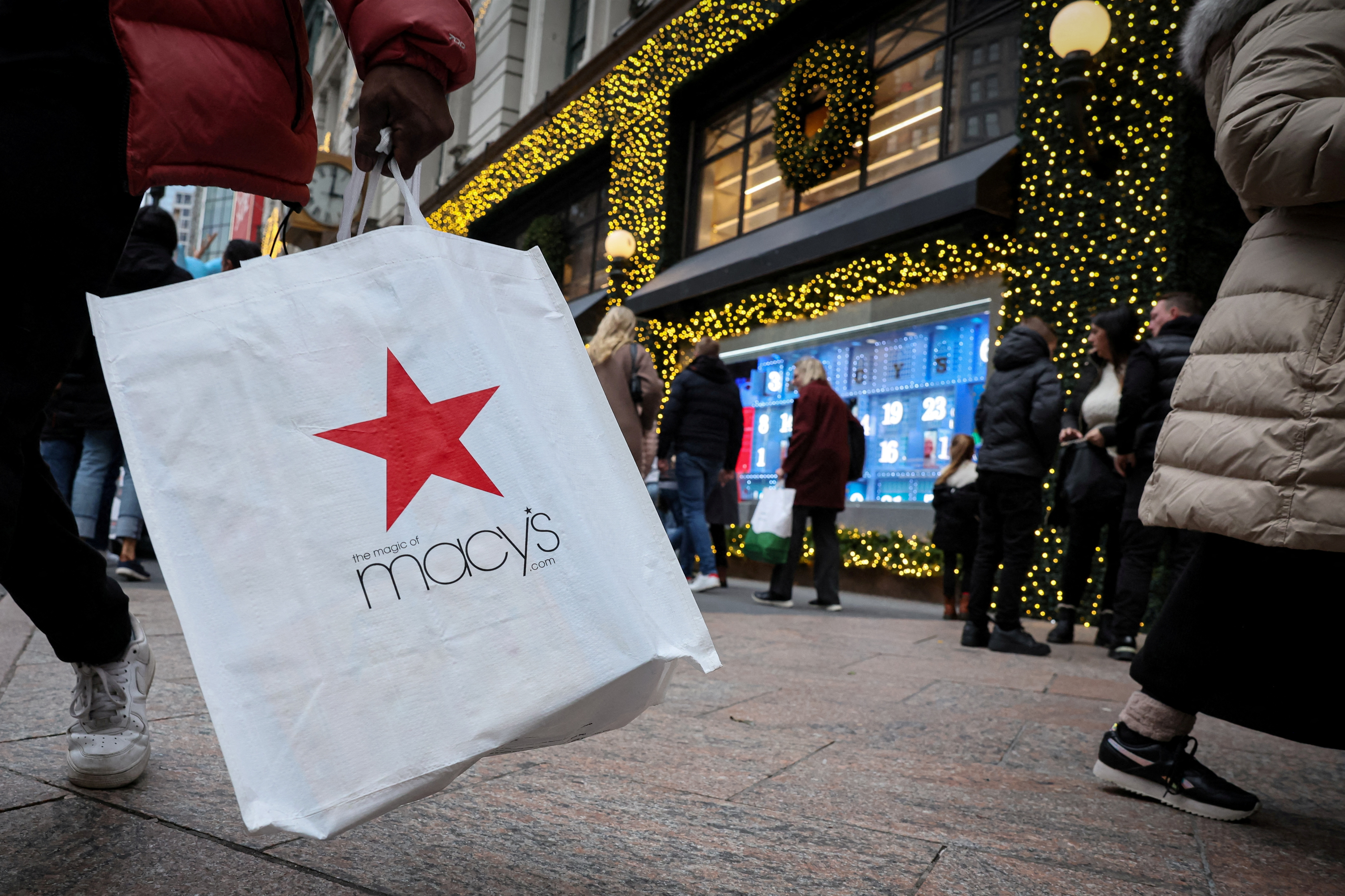 A customer exits the Macy's flagship department store in midtown Manhattan in New York