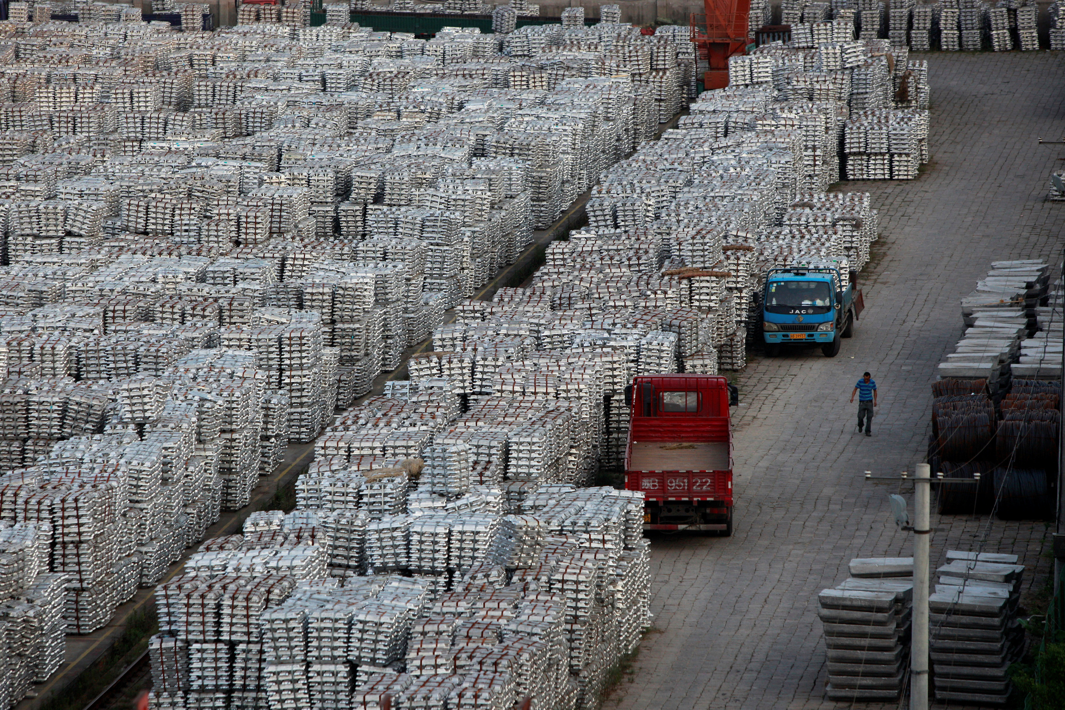 A worker walks through an aluminium ingots depot in Wuxi