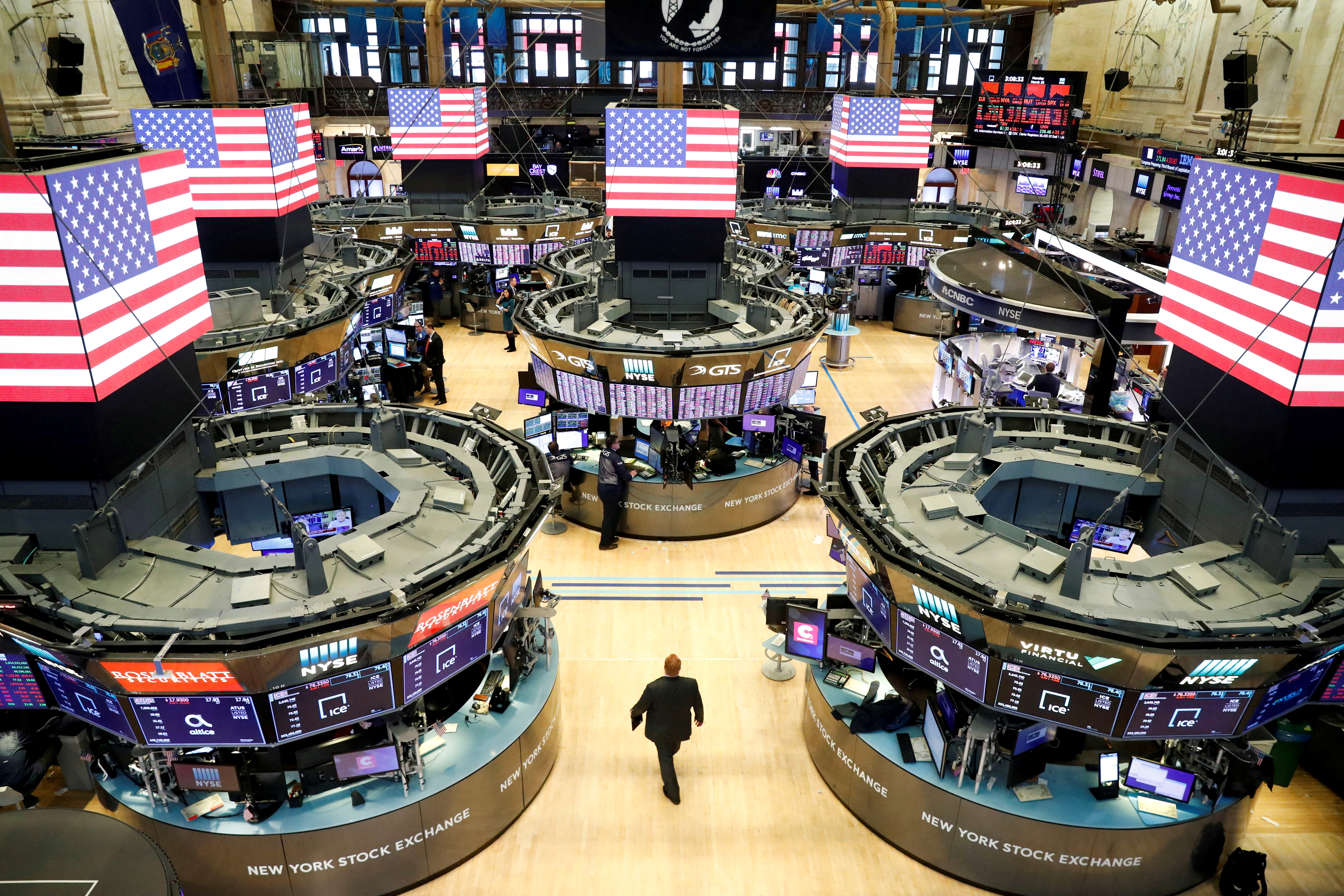 Traders work on the floor of the New York Stock Exchange shortly as coronavirus disease (COVID-19) cases in the city of New York rise
