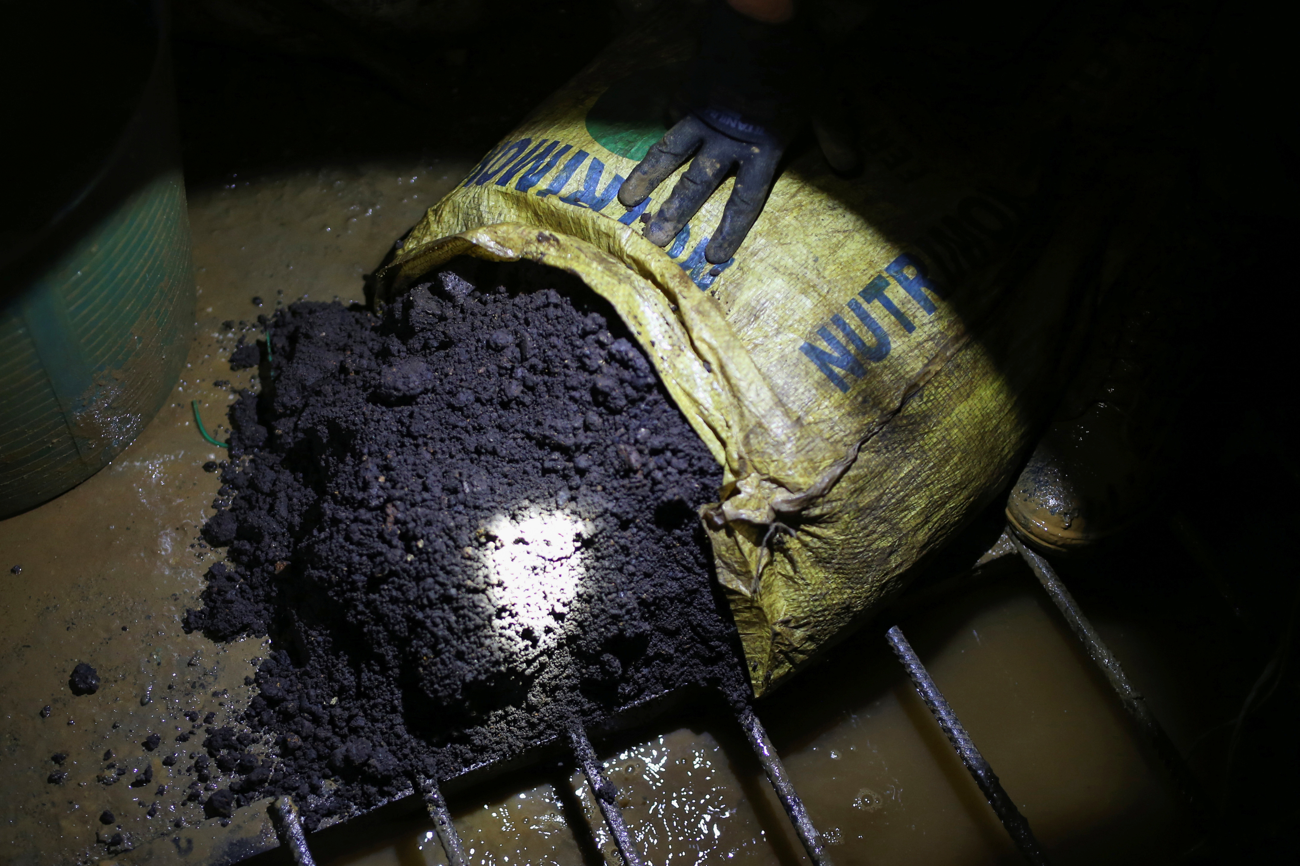 Mineral material extracted from an illegal gold mine is seen inside an underground room where the material is processed, in Buritica