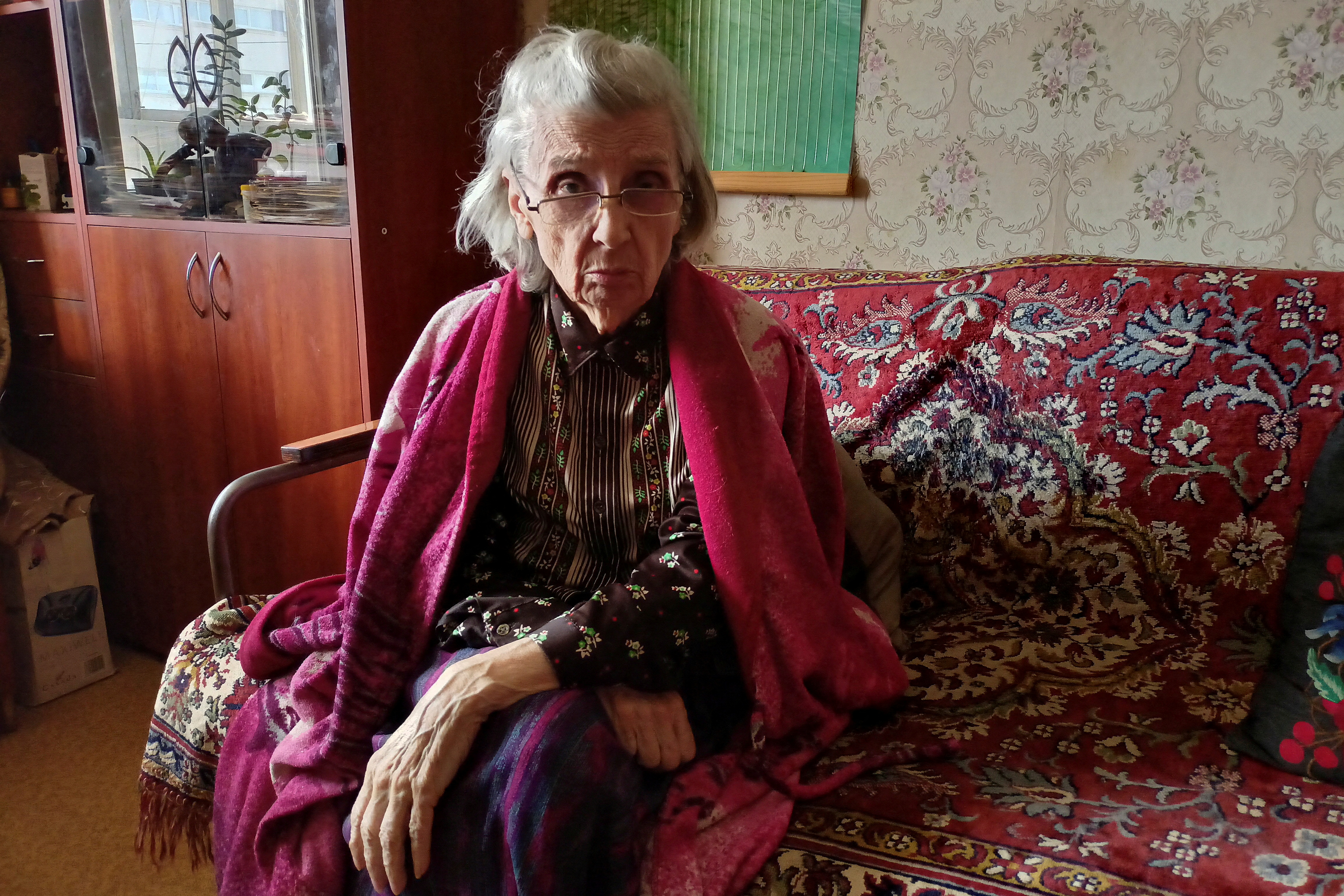 Margarita Morozova, who survived the siege of Leningrad during World War II, poses for a picture at her apartment in Kharkiv