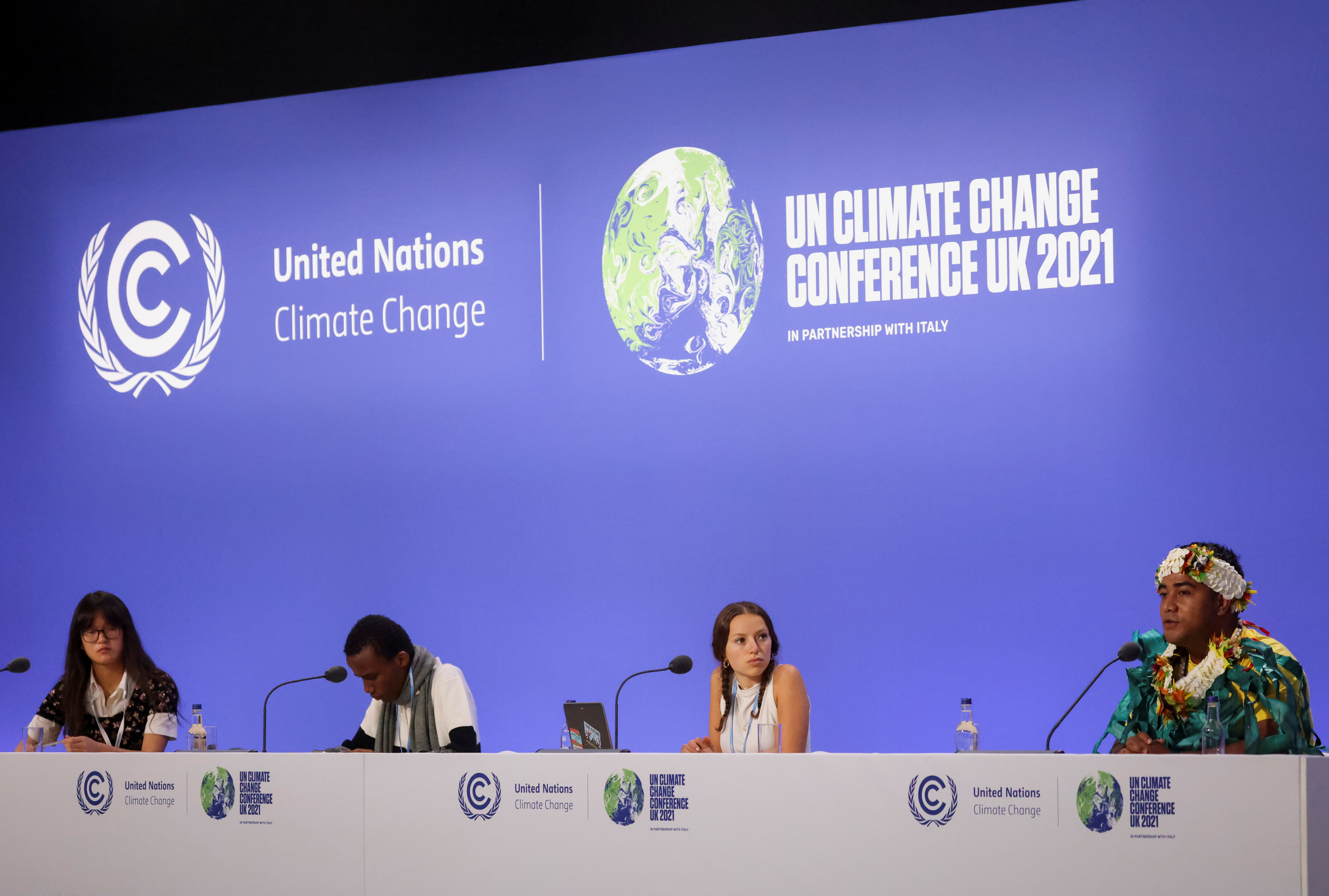 Youth climate activists Magali Cho Lin Wing from Britain, Eric Njuguna from Kenya, Nicole Becker from Argentina, and Kato Ewekia Taomia from Tuvalu take part in a session during the UN Climate Change Conference (COP26), in Glasgow, Scotland, Britain, November 4, 2021. REUTERS/Yves Herman