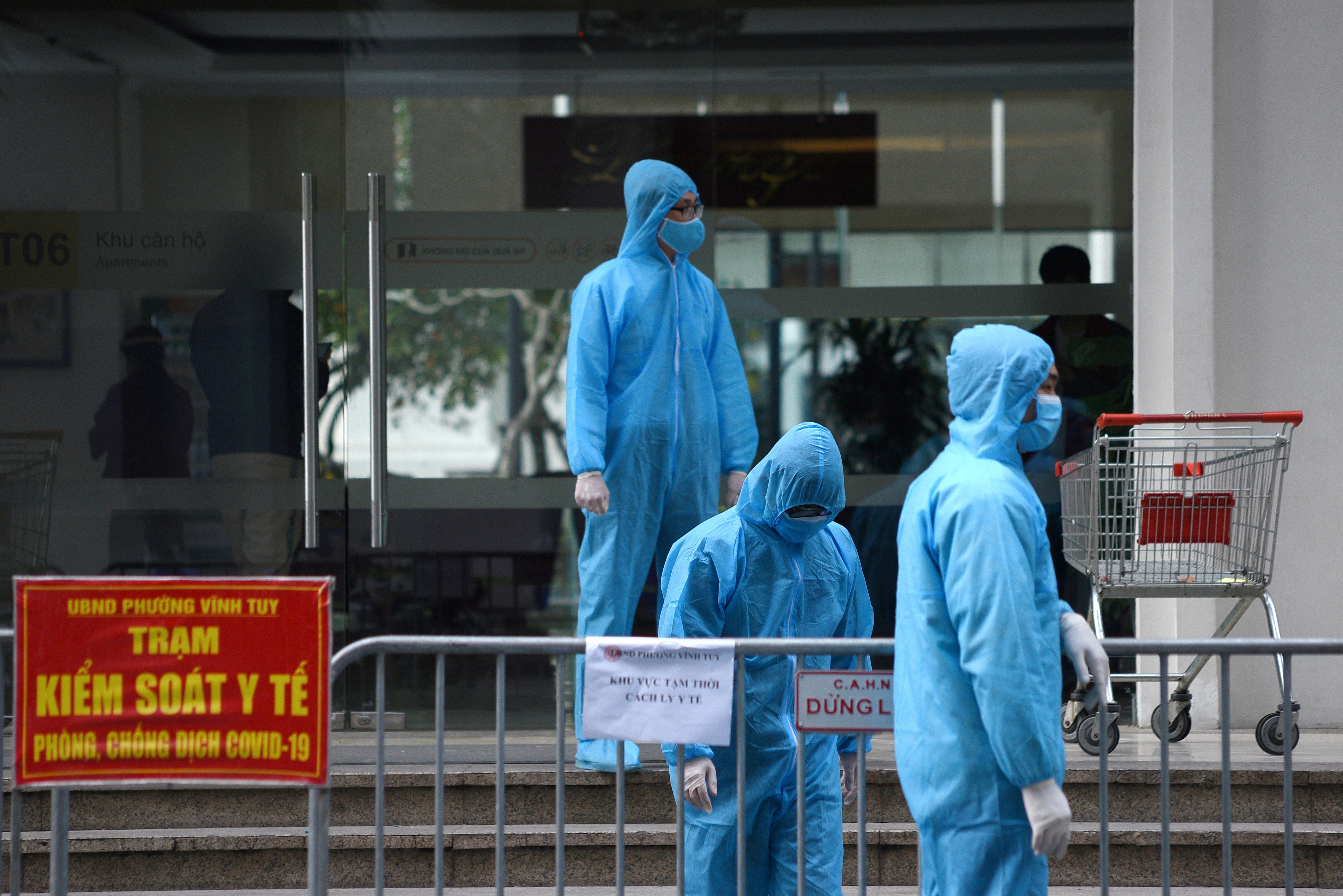 IFILE PHOTO: Medical workers in protective suits stand outside a quarantined building amid the coronavirus disease outbreak in Hanoi