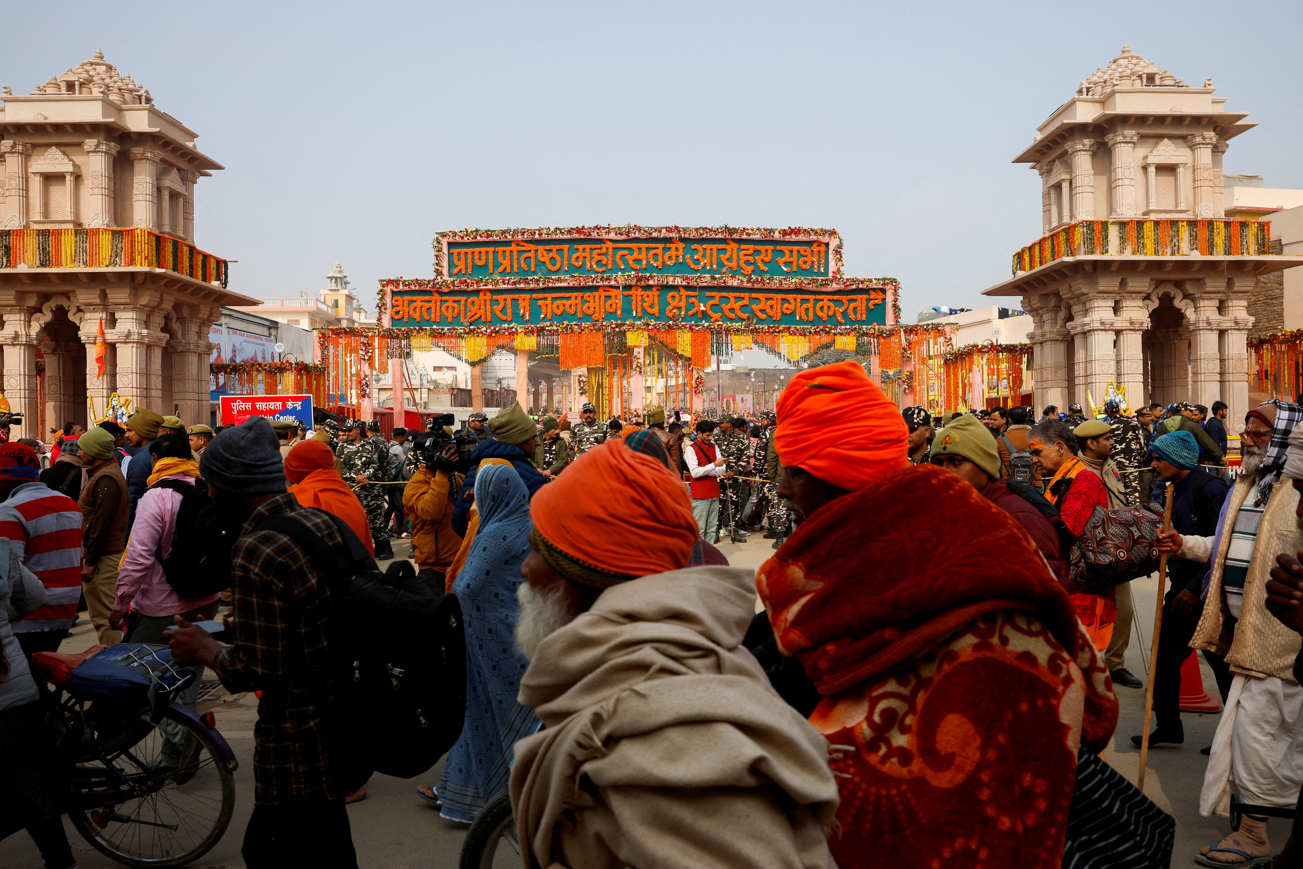 Hindu devotees wait to enter the Hindu god Lord Ram temple after its inauguration in Ayodhya