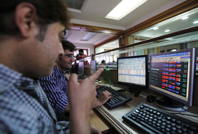 Brokers trade on computer terminals at a stock brokerage firm in Mumbai