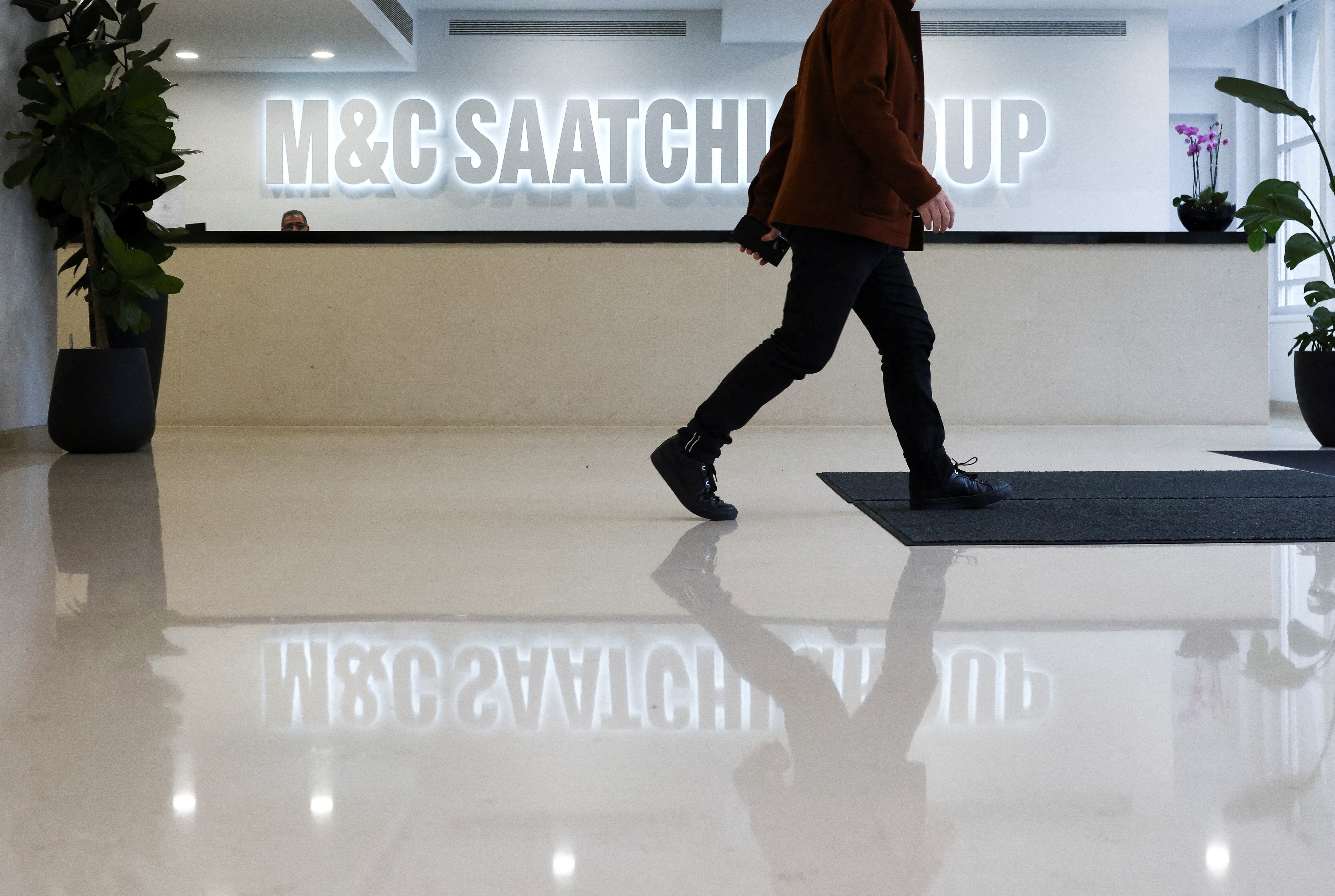 A person walks through the reception of the M&C Saatchi office in central London, Britain, January 6, 2022. REUTERS/Henry Nicholls
