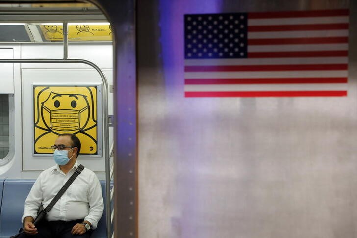 A commuter wears a mask while riding the subway as cases of the infectious coronavirus Delta variant continue to rise in New York City, New York