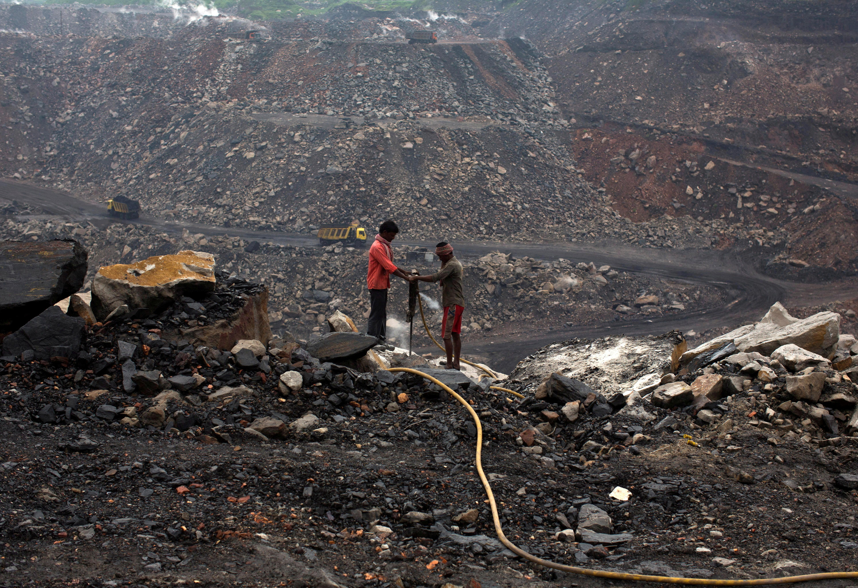 Workers drill at an open cast coal field at Dhanbad district in Jharkhand