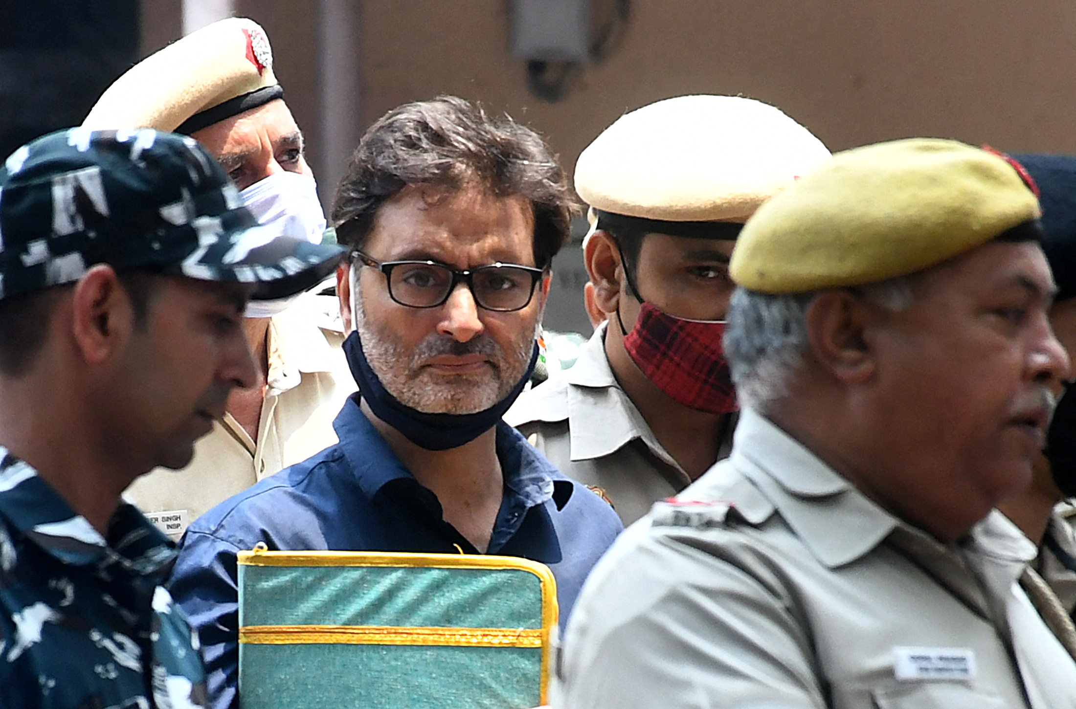 JKLF's Malik is escorted by Indian police officers at a court premises in New Delhi