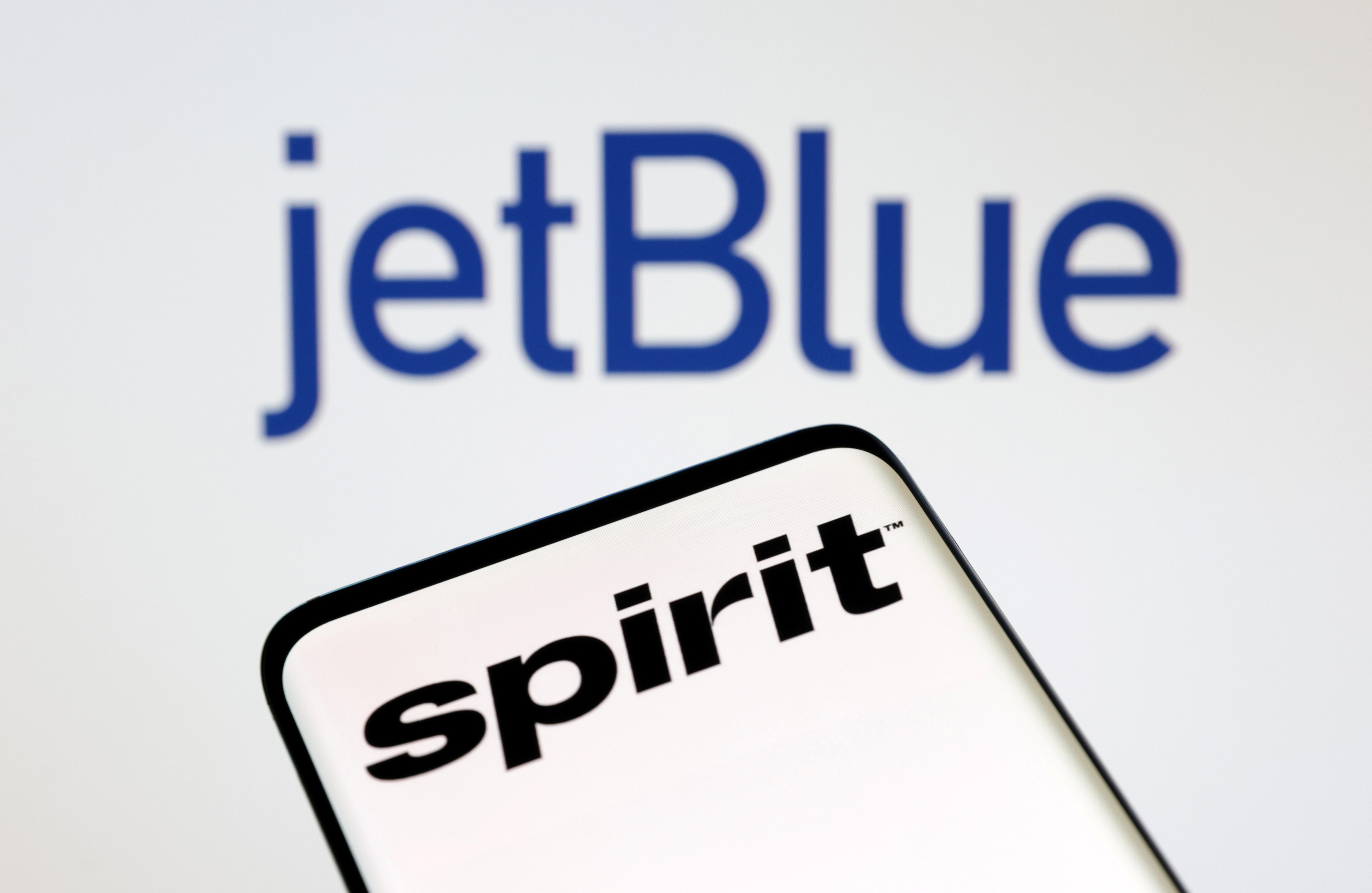 comIllustration shows Spirit Airlines and jetBlue Airways logos