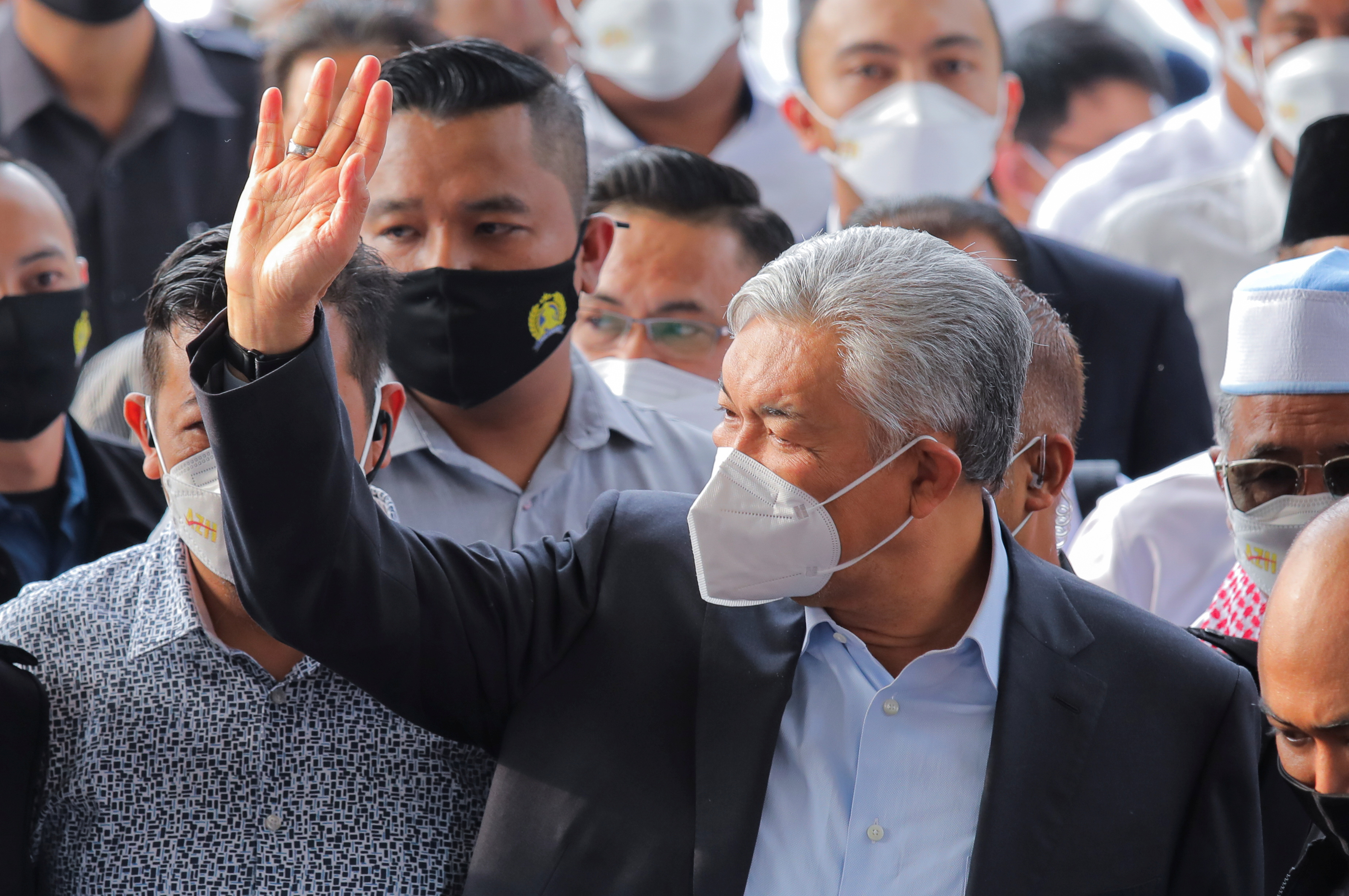 Former Malaysian deputy prime minister Ahmad Zahid Hamidi waves to his supporters at the Kuala Lumpur High Court