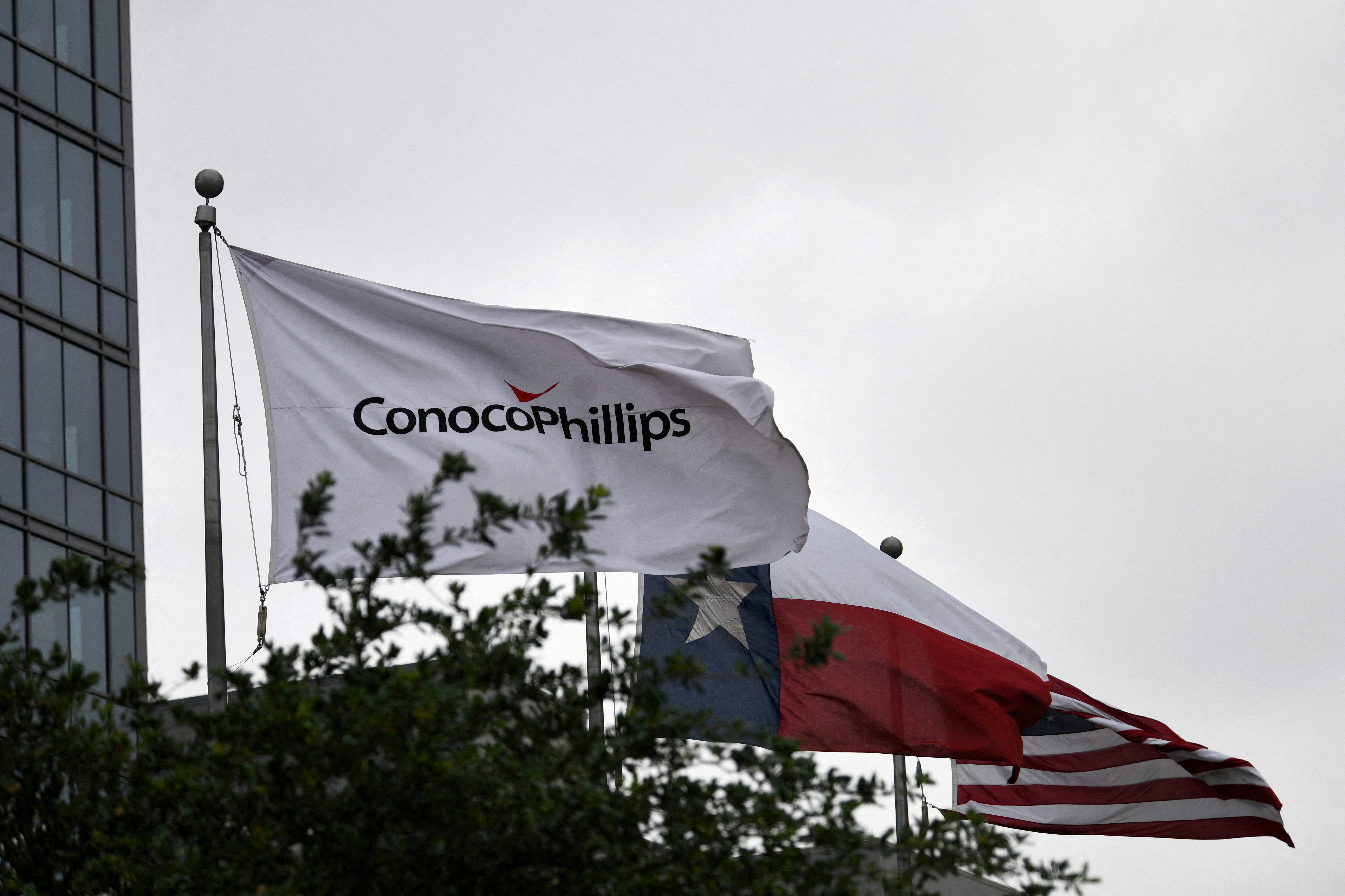 Flags fly outside ConocoPhillips offices in Houston