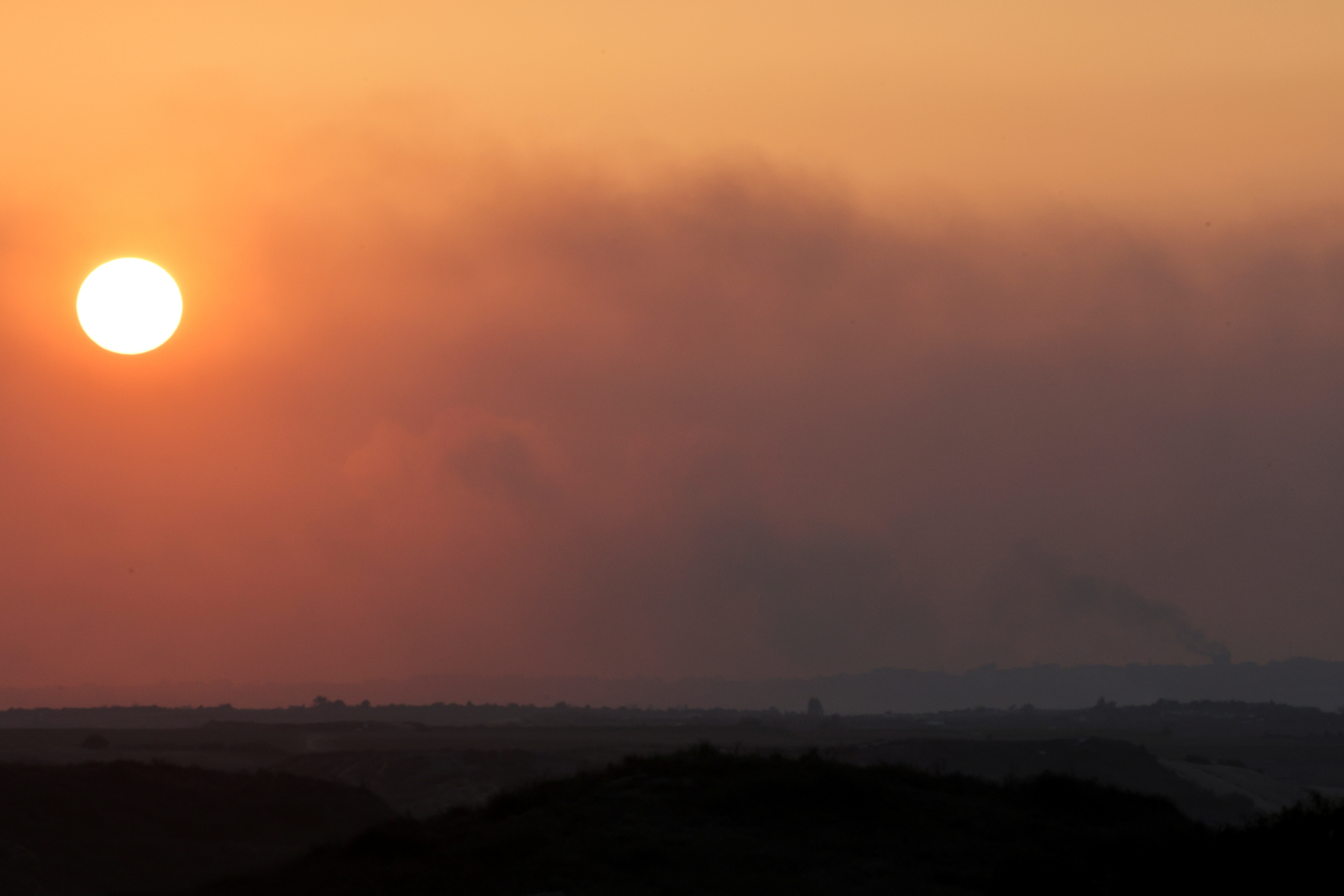 Smoke rises over Gaza at sunset, as seen from southern Israel