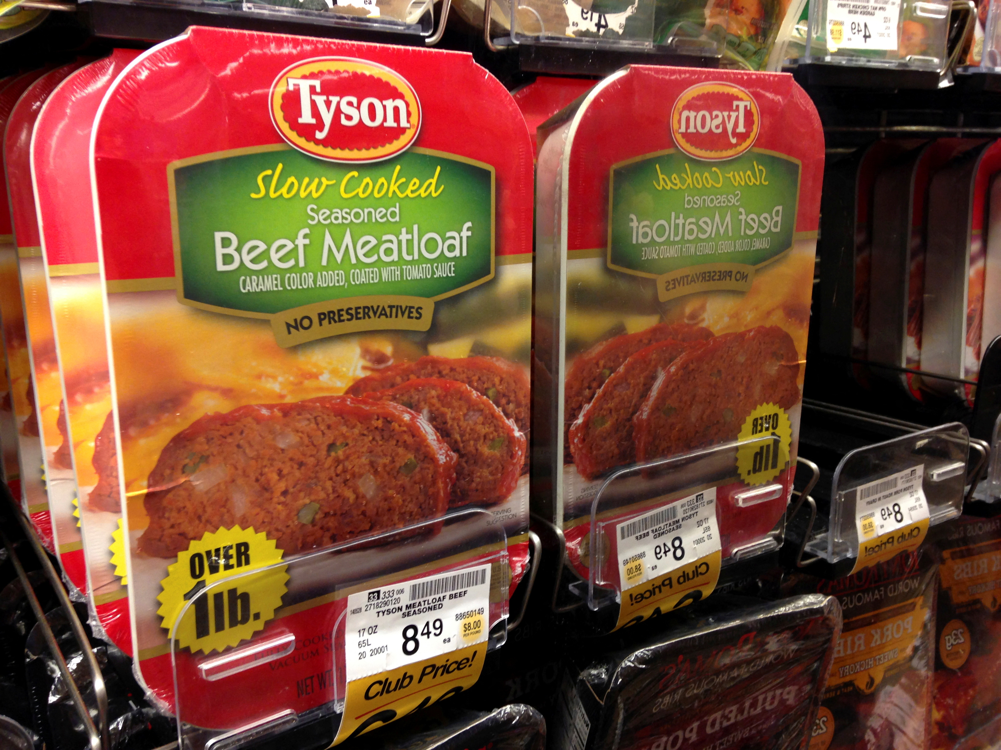 Packages of Tyson food beef meat loaf are reflected in a mirror as they sit on a refrigerator shelf for sale at a grocery store in Encinitas, California, United States