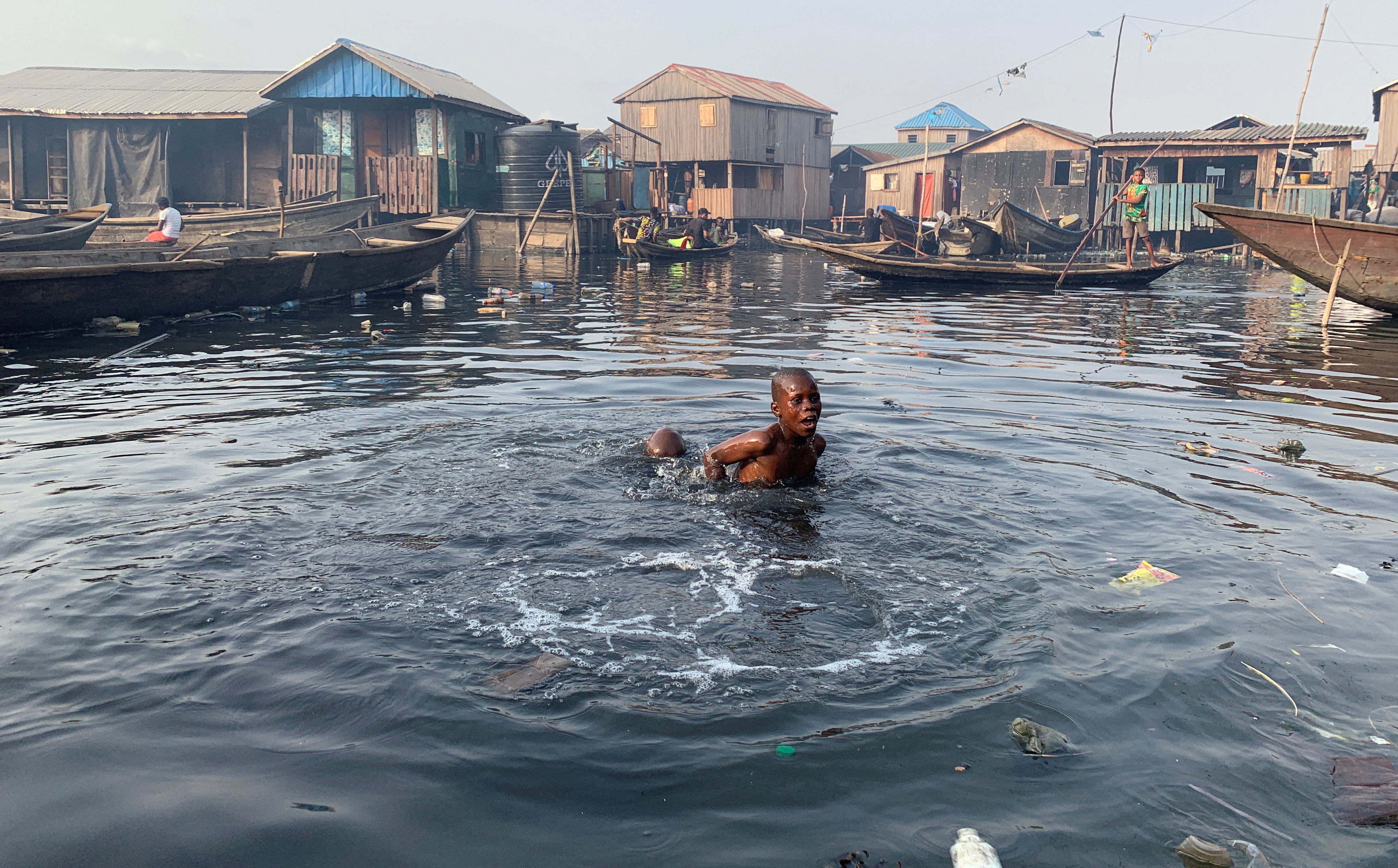 A boy swims in the polluted water of the Makoko community in Lagos