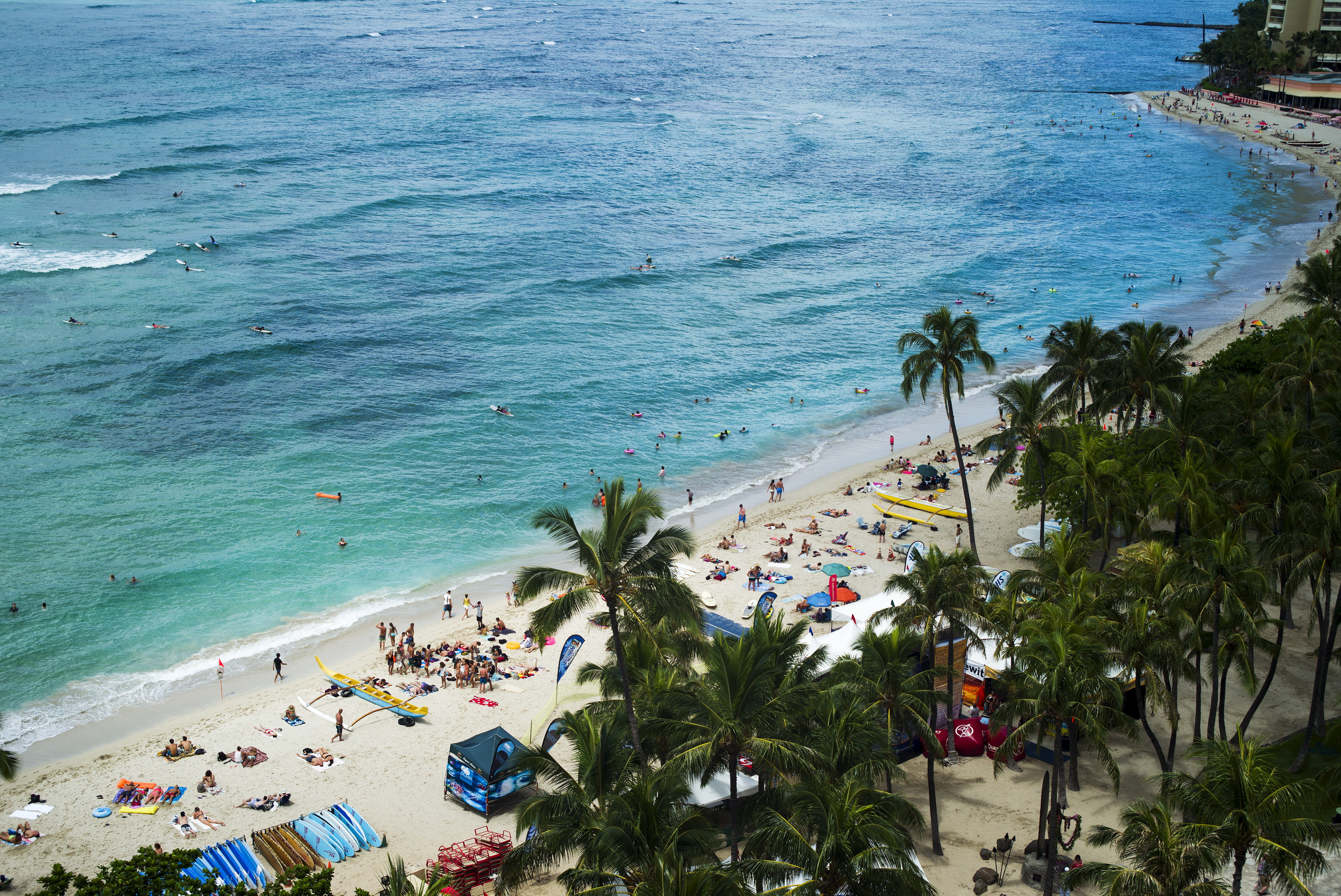 People are pictured at Waikiki Beach in Honolulu, Hawaii