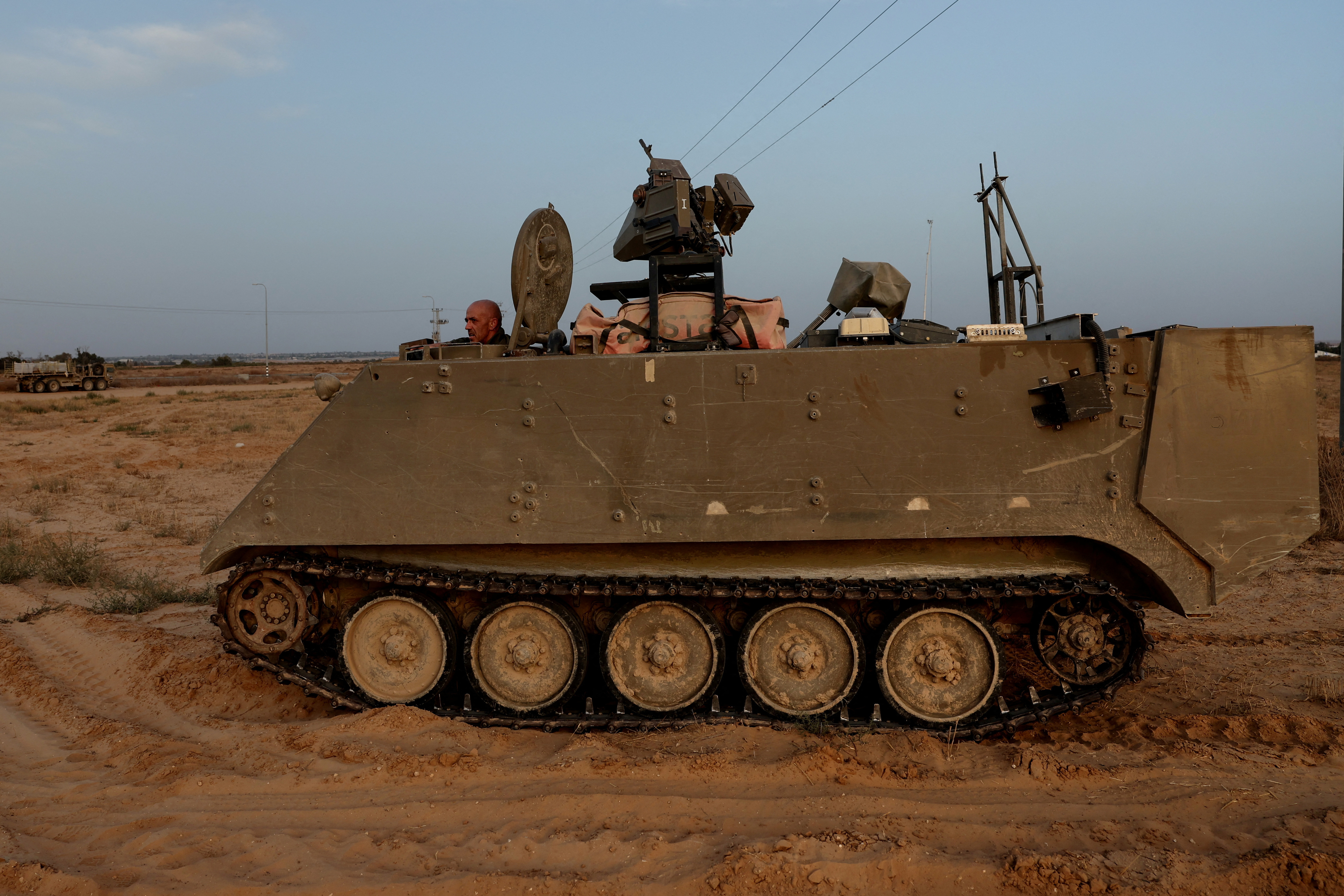 An Israeli solider drives an armored personnel carrier, as military operations continue in the southern Gaza city of Rafah, at an area outside Kerem Shalom, Israel