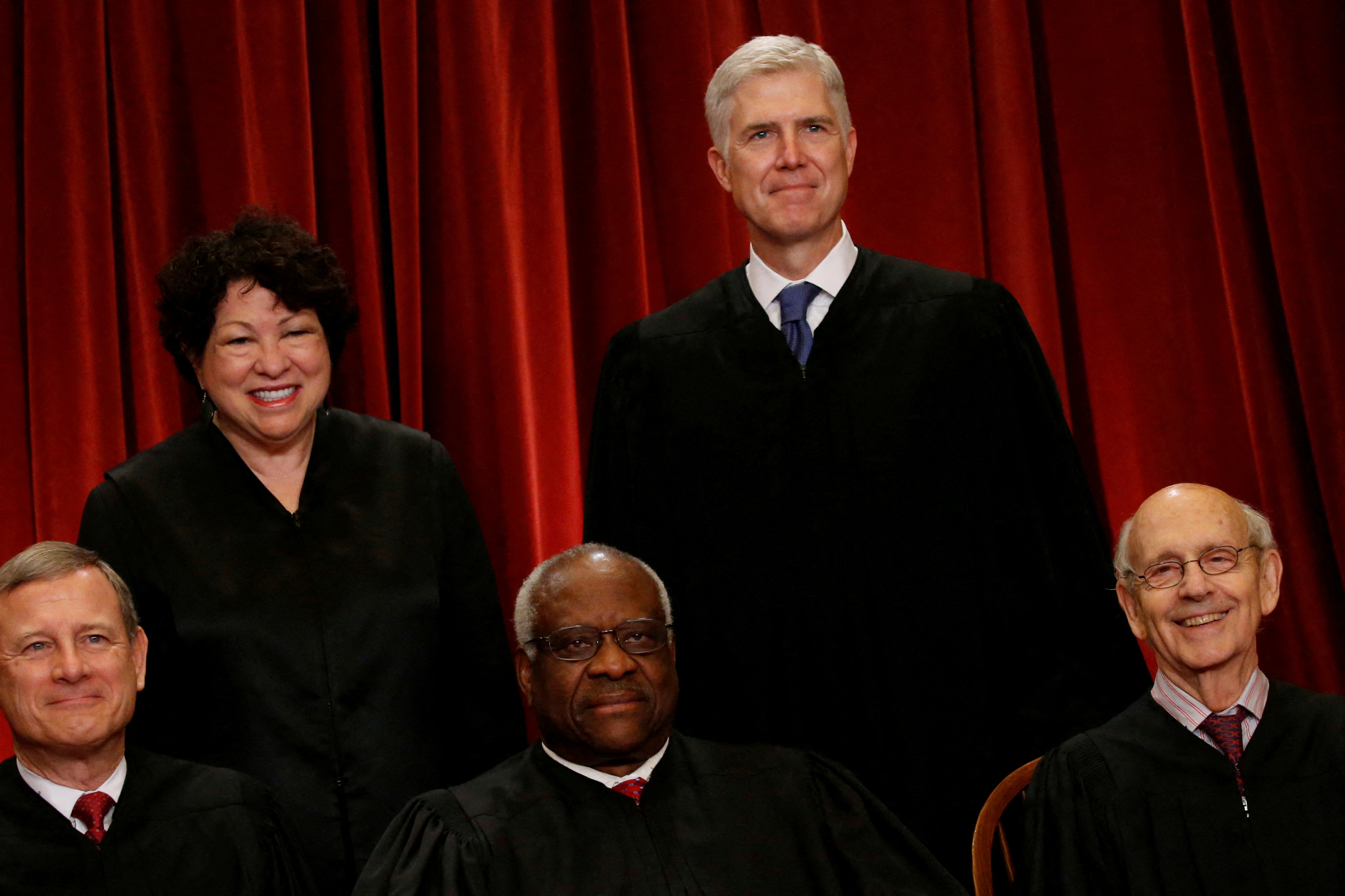 Gorsuch smiles as he joins his fellow justices for a new U.S. Supreme Court family photo including him, their most recent addition, at the Supreme Court building in Washington