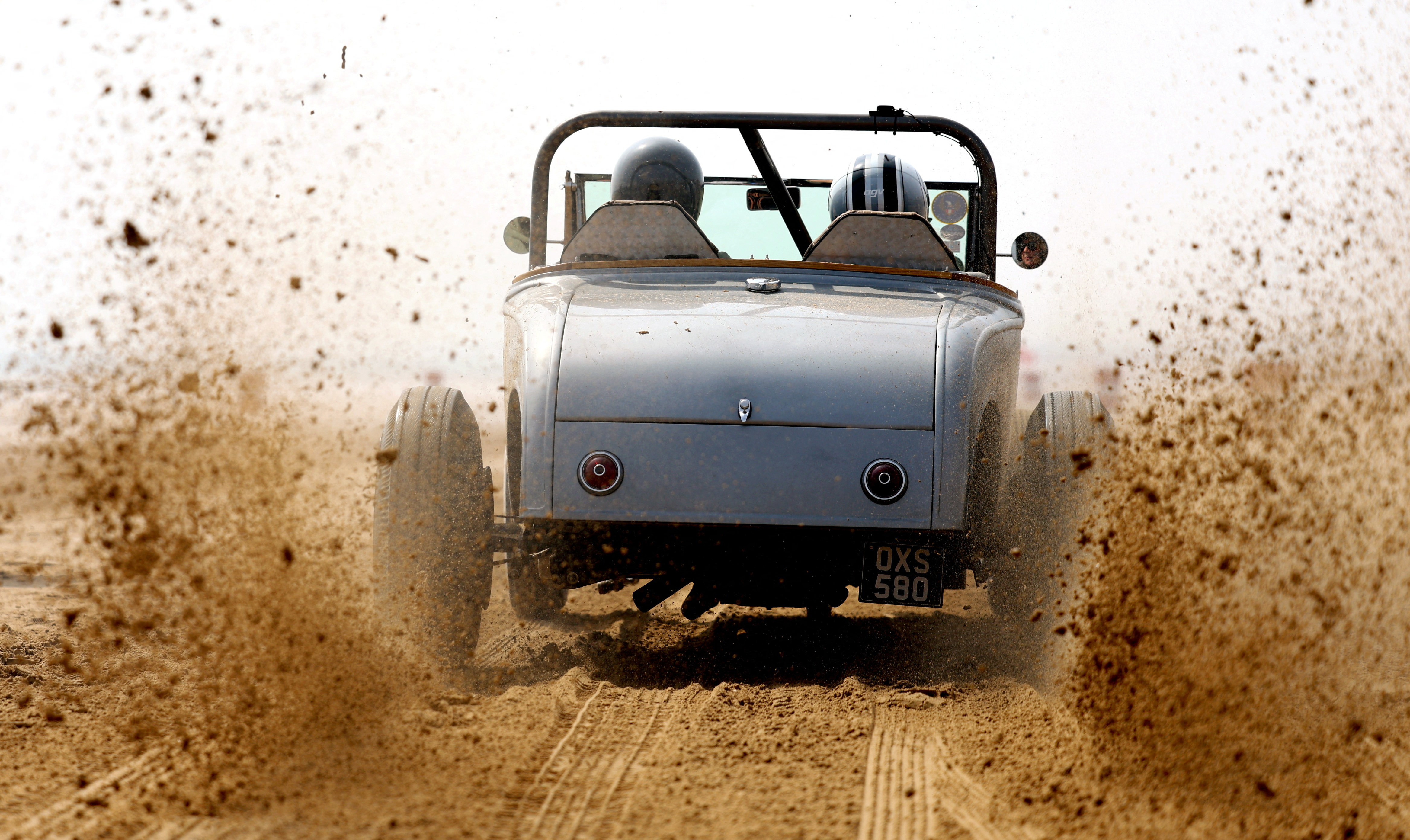 Motoring enthusiasts take part in the 'Race The Waves' classic car and motorcycle meet at the beach in Bridlington