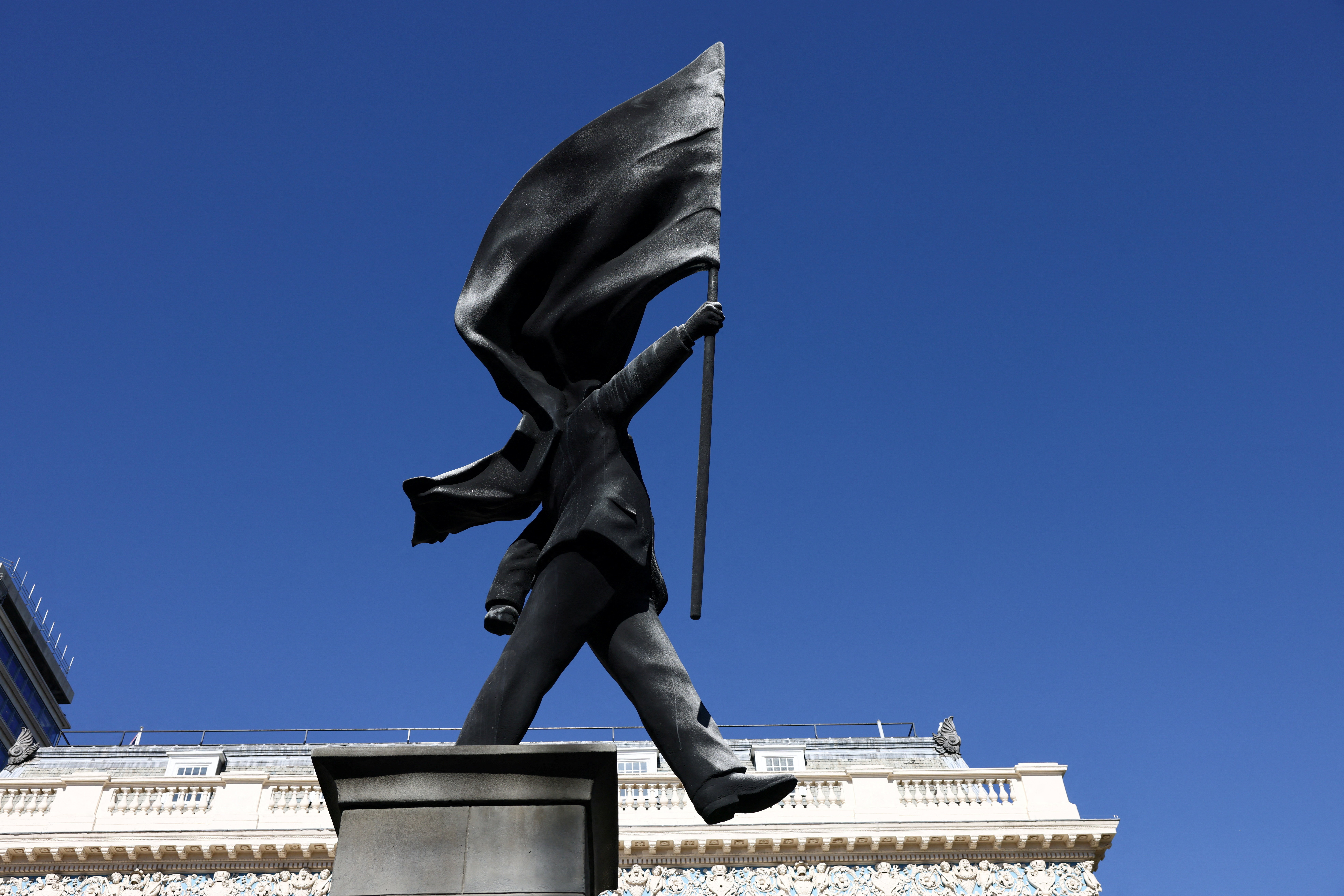 London hails new Banksy statue of man blinded by flag | Reuters
