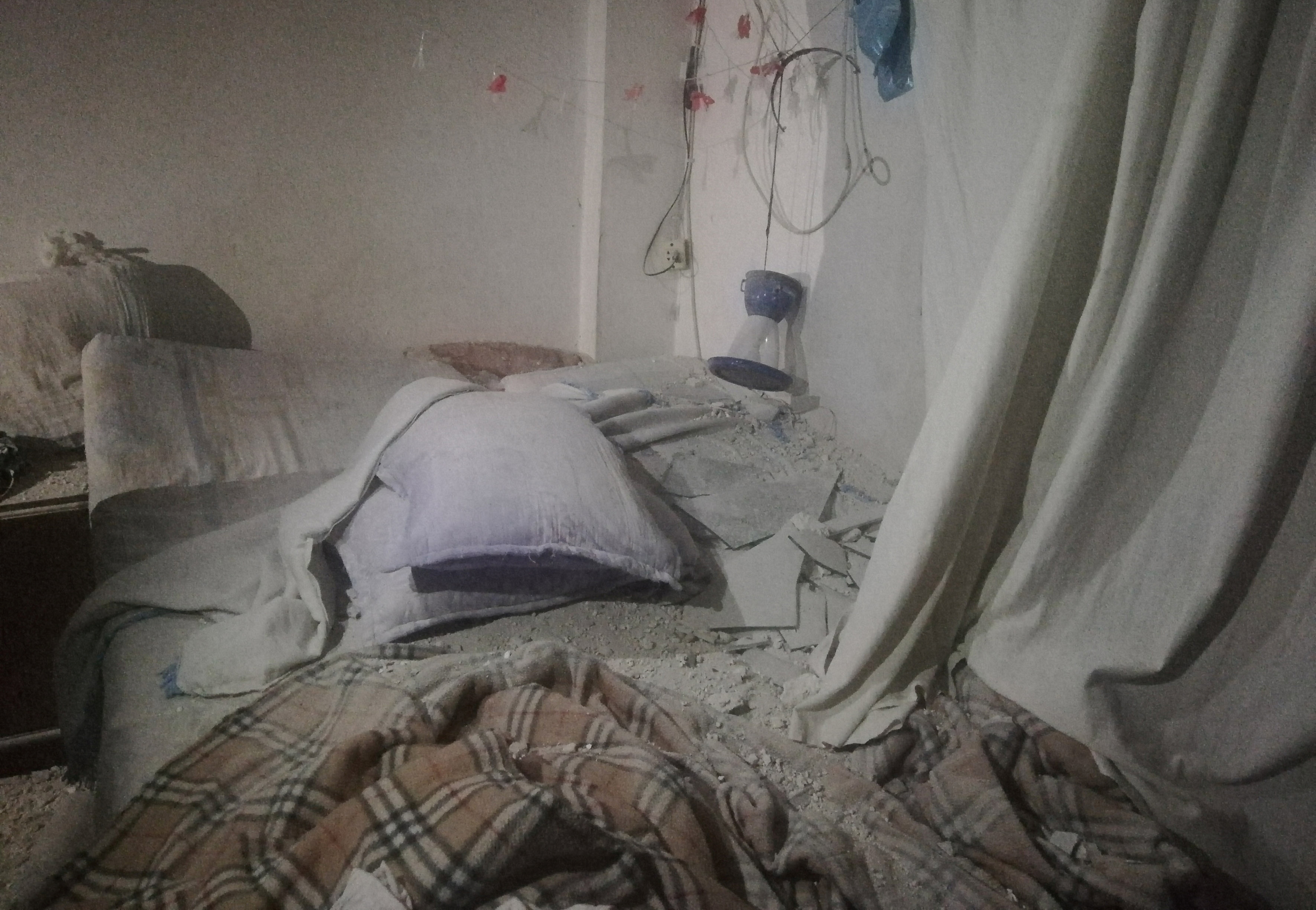A view shows the damage inside a room after pre-dawn raids on the Mediterranean port region of Latakia