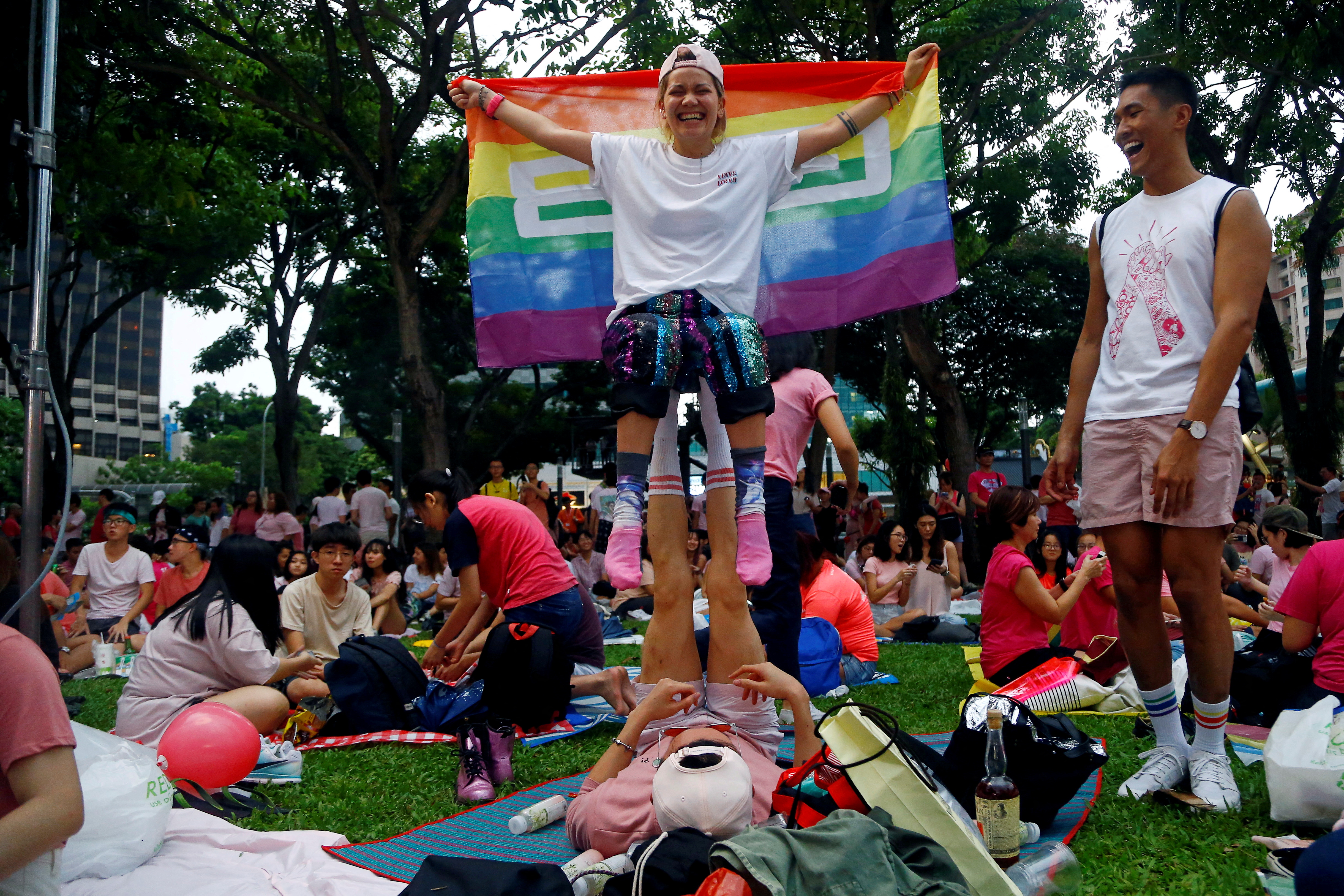 A participant holds up a rainbow flag at Pink Dot, an annual event organised in support of the LGBT community, at the Speakers' Corner in Hong Lim Park in Singapore