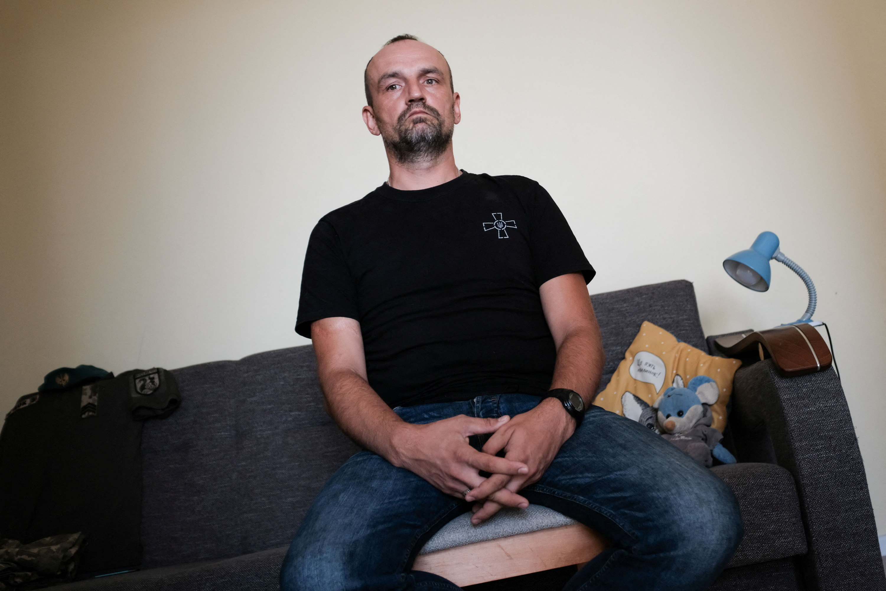 Ukrainian soldier Dovzhenko, 41 looks on during an interview for Reuters at his home in Wroclaw