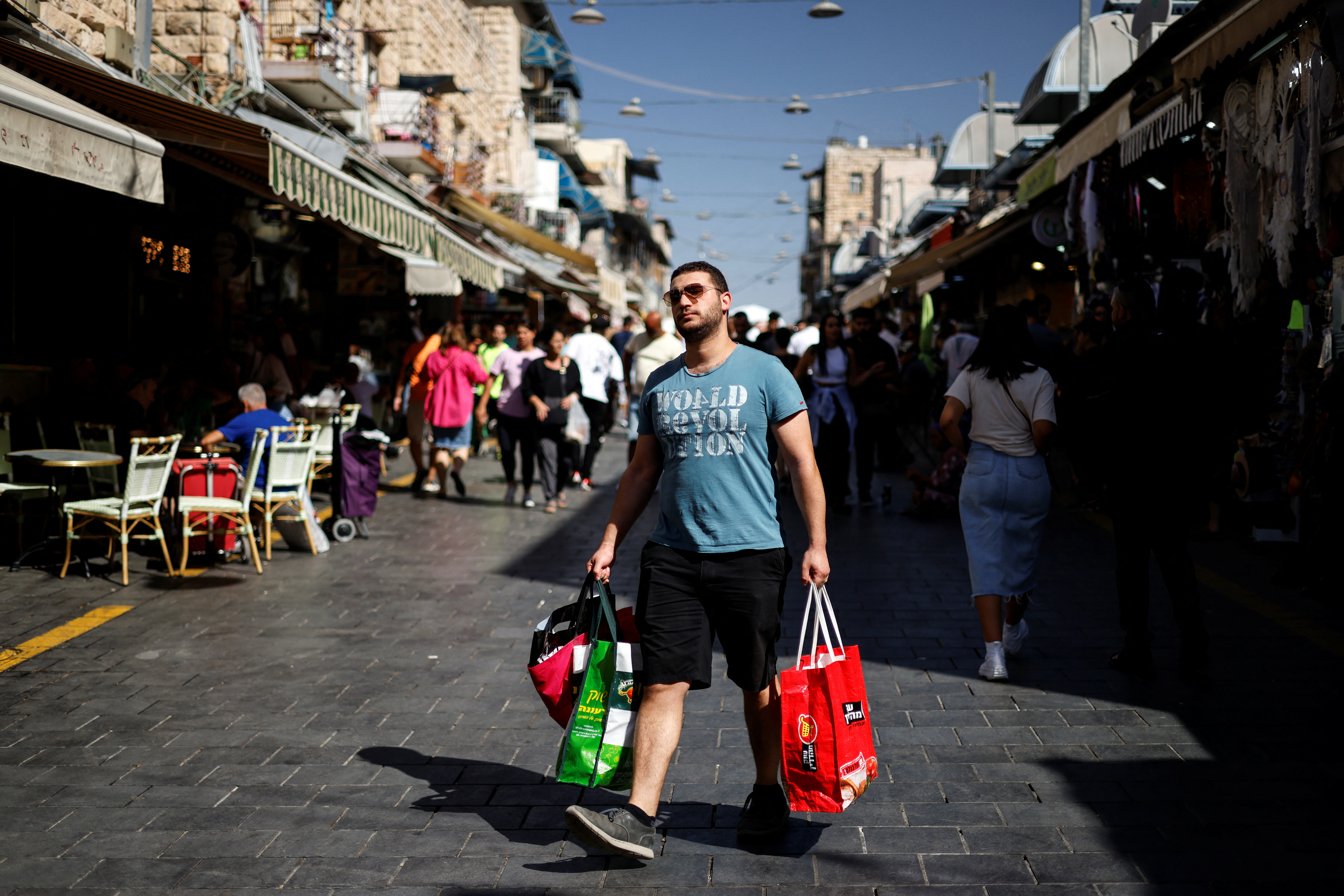 Shoppers carry their groceries through Mahane Yehuda market in Jerusalem