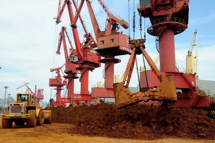 Iron ores are unloaded at a port in Lianyungang