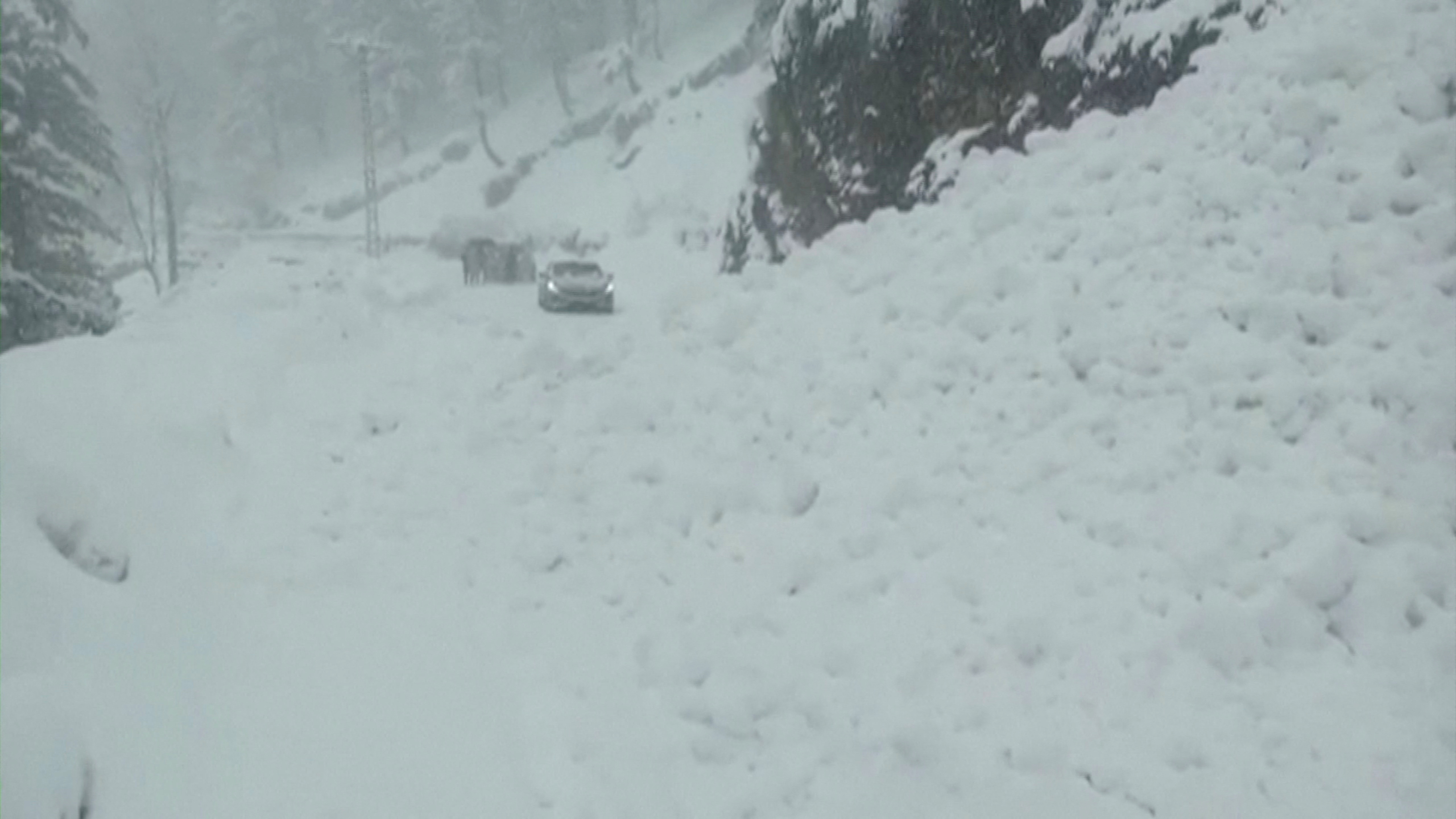 Vehicles are seen on a snowy road, in Murree, northeast of Islamabad, Pakistan in this still image taken from a video January 8, 2022. PTV/REUTERS TV via REUTERS  