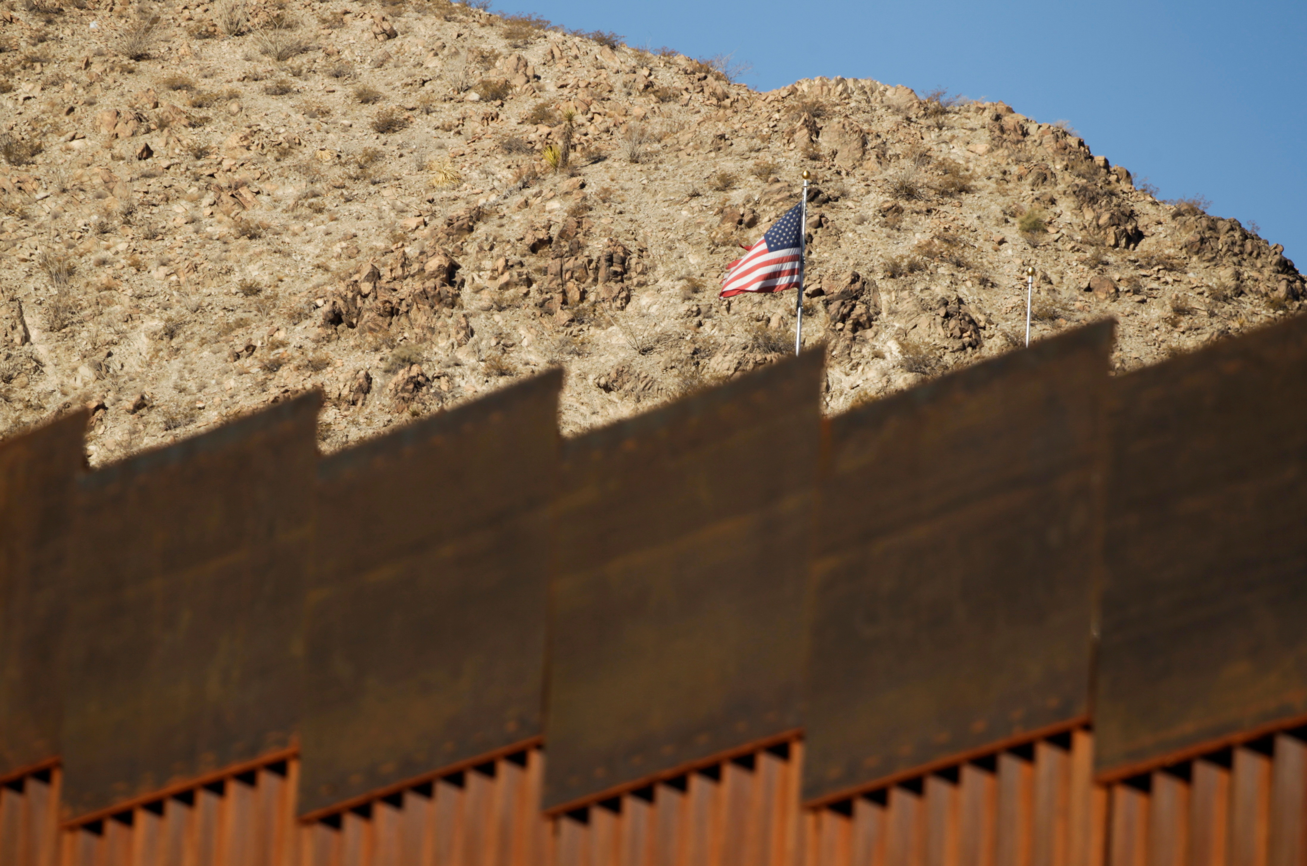 The U.S. flag is seen near a section of the border fence between Mexico and United States, as pictured from Ciudad Juarez