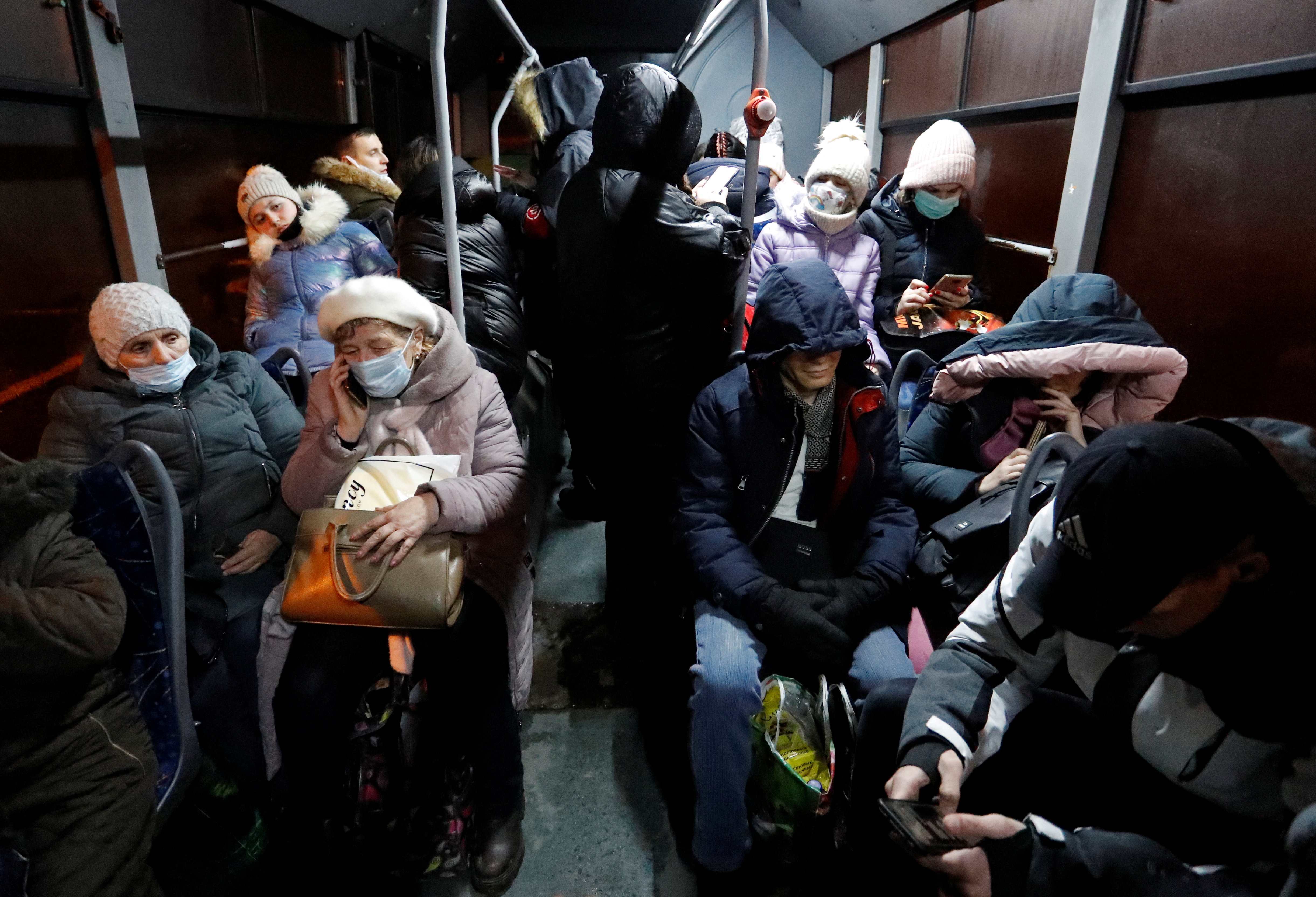 Se ve a personas dentro de un autobús dispuesto para evacuar a los residentes locales, en la ciudad controlada por los rebeldes de Donetsk, Ucrania, el 18 de febrero de 2022. REUTERS/Alexander Ermochenko